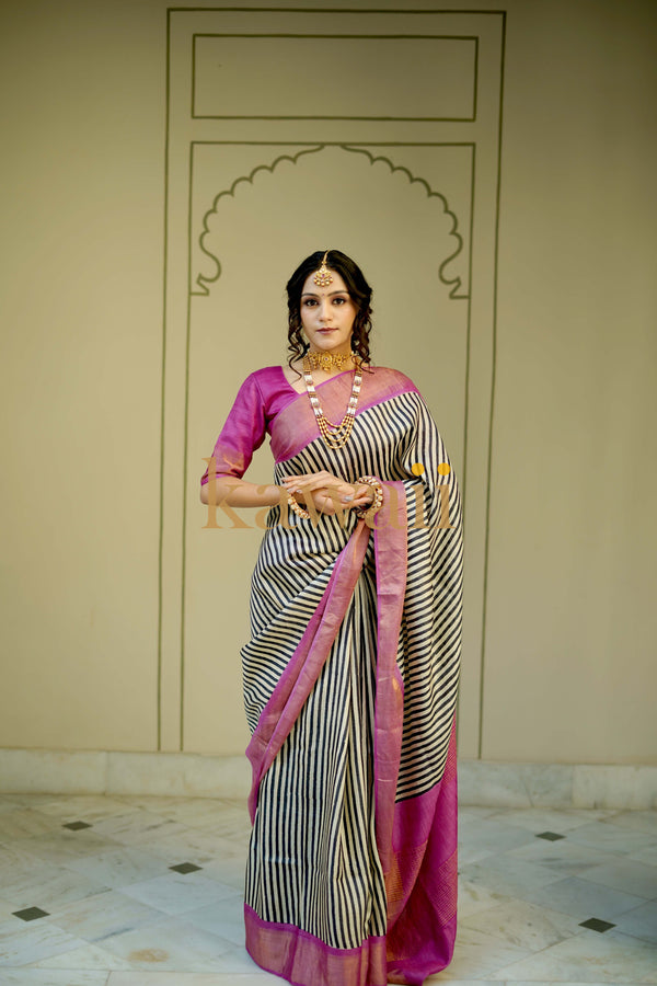 Woman showcasing handloom tussar silk saree with pink zari border and black stripes – Block Print Silk Sarees design