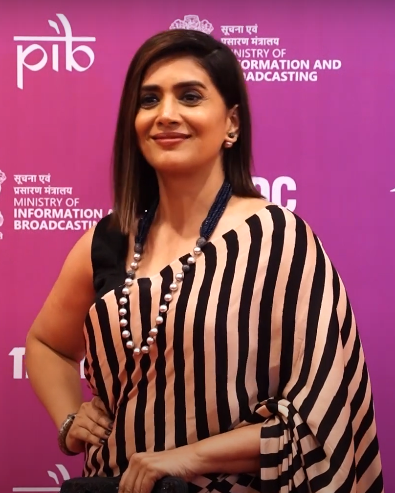 Kawaii ajrakh saree with black and beige vertical stripes worn by a woman with pearl necklace