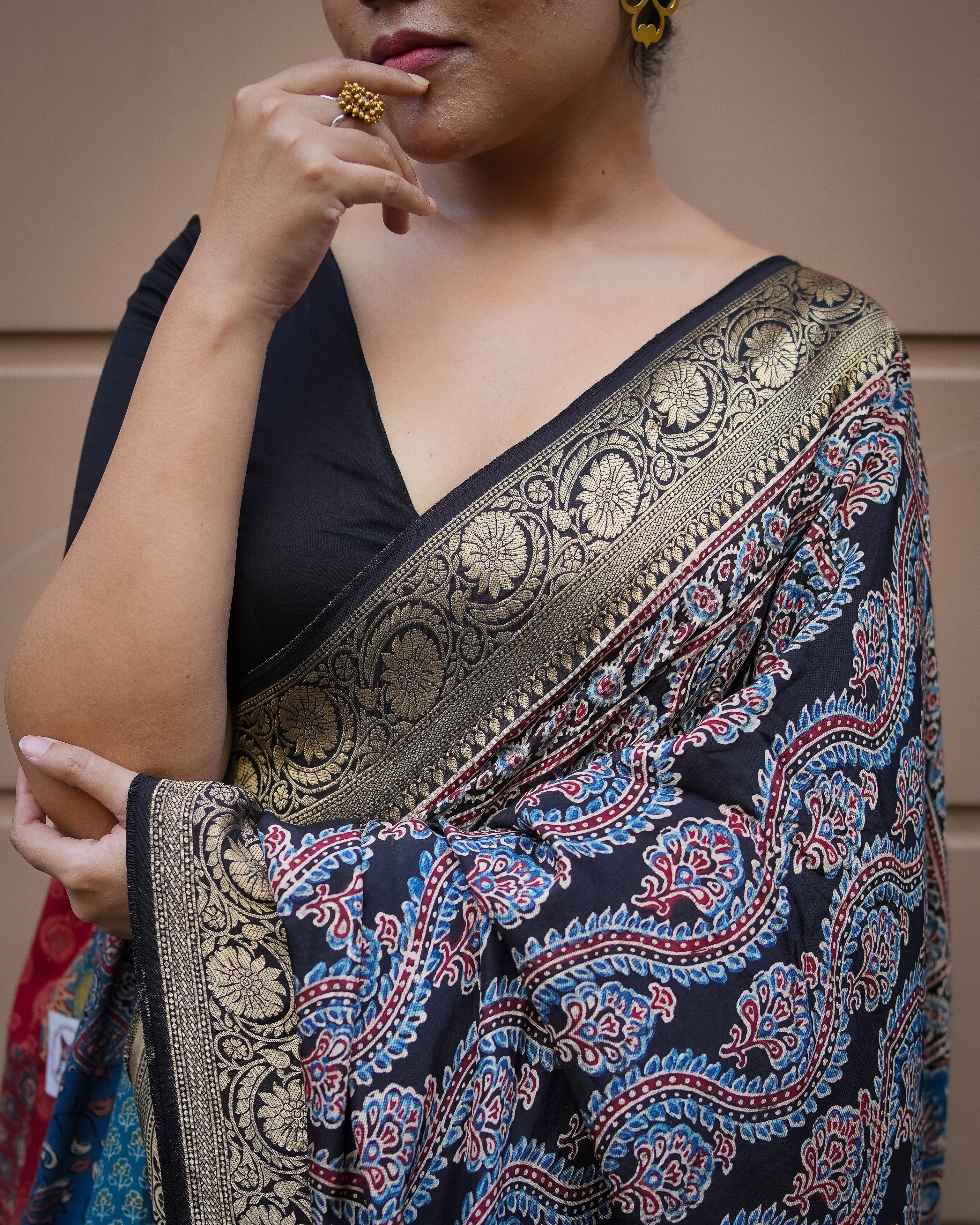 Kawaii ajrakh saree with intricate gold border and traditional blue and red patterns on black fabric