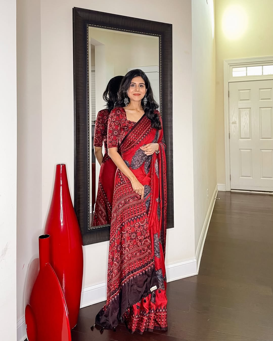 Kawaii ajrakh saree in red and black worn by woman standing in front of mirror indoors