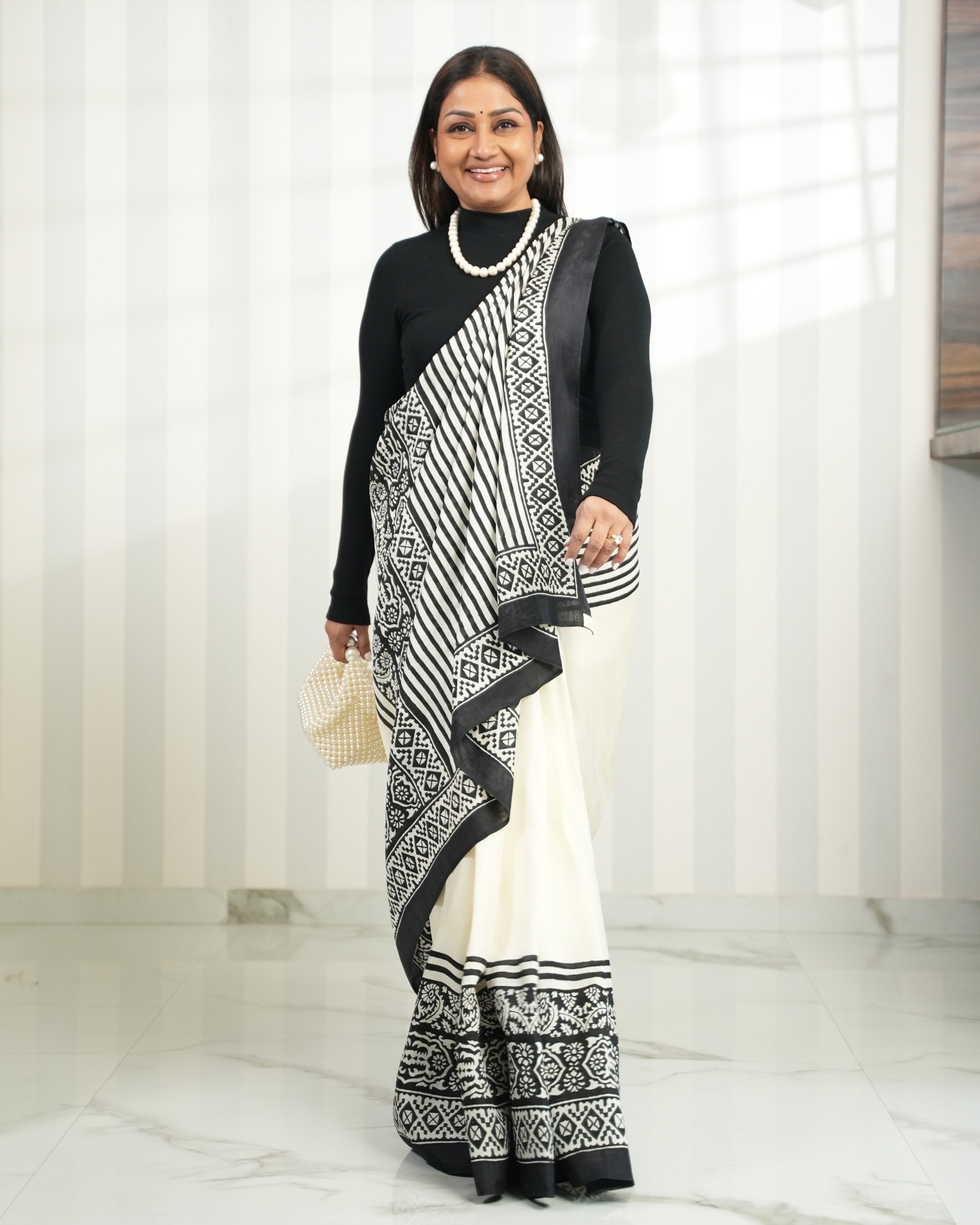 Elegant Kawaii block print saree in white and black with intricate patterns, styled with a black top