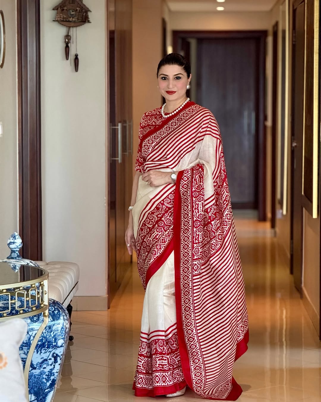 Kawaii block print saree in red and white with intricate traditional patterns worn by woman indoors