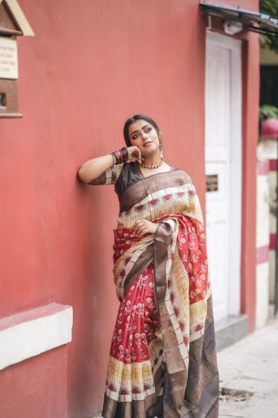 Woman wearing a red and beige block print saree by Kawaii with traditional floral patterns