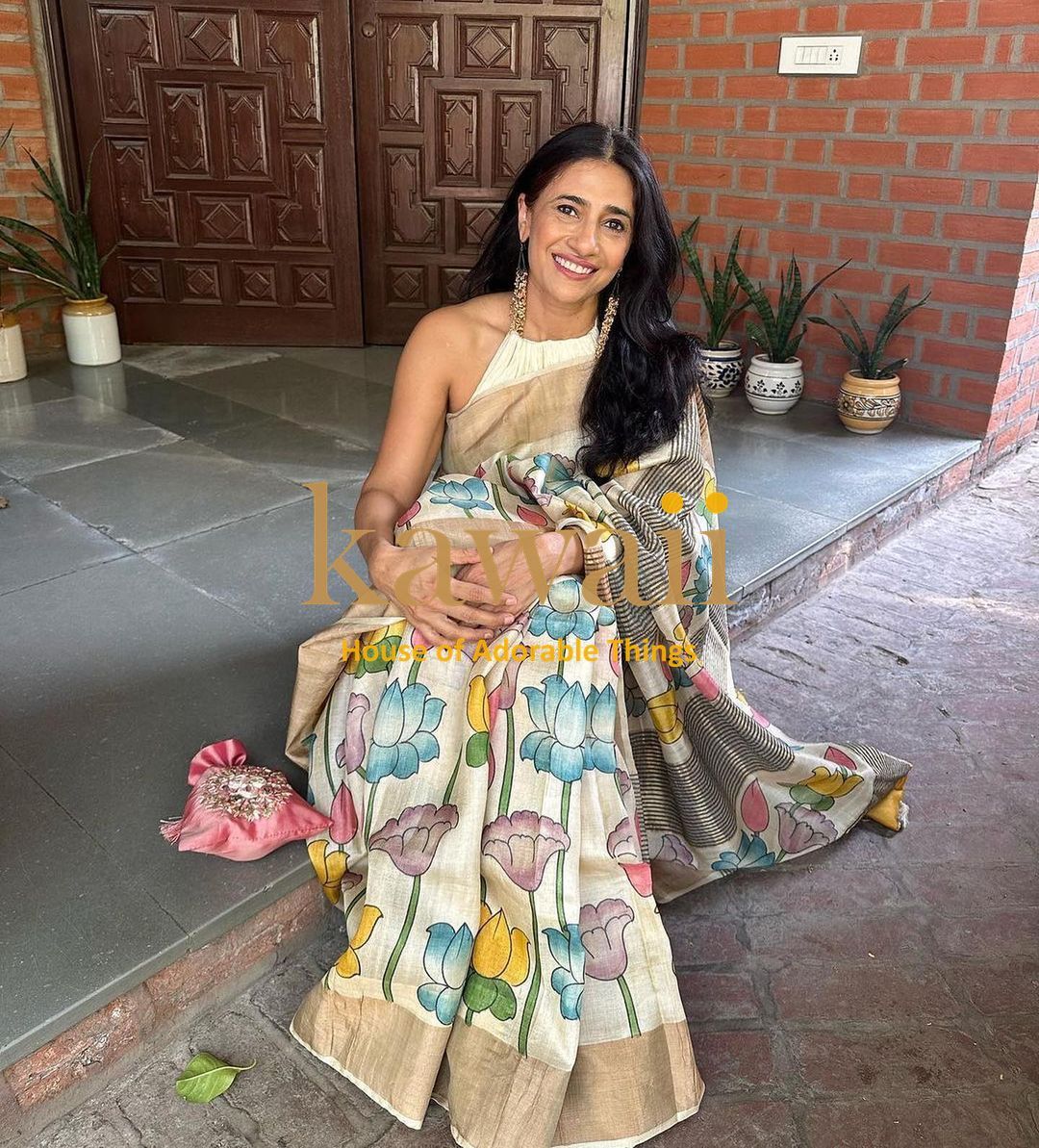 Kalamkari saree in cream with colorful floral designs, crafted for elegant traditional wear