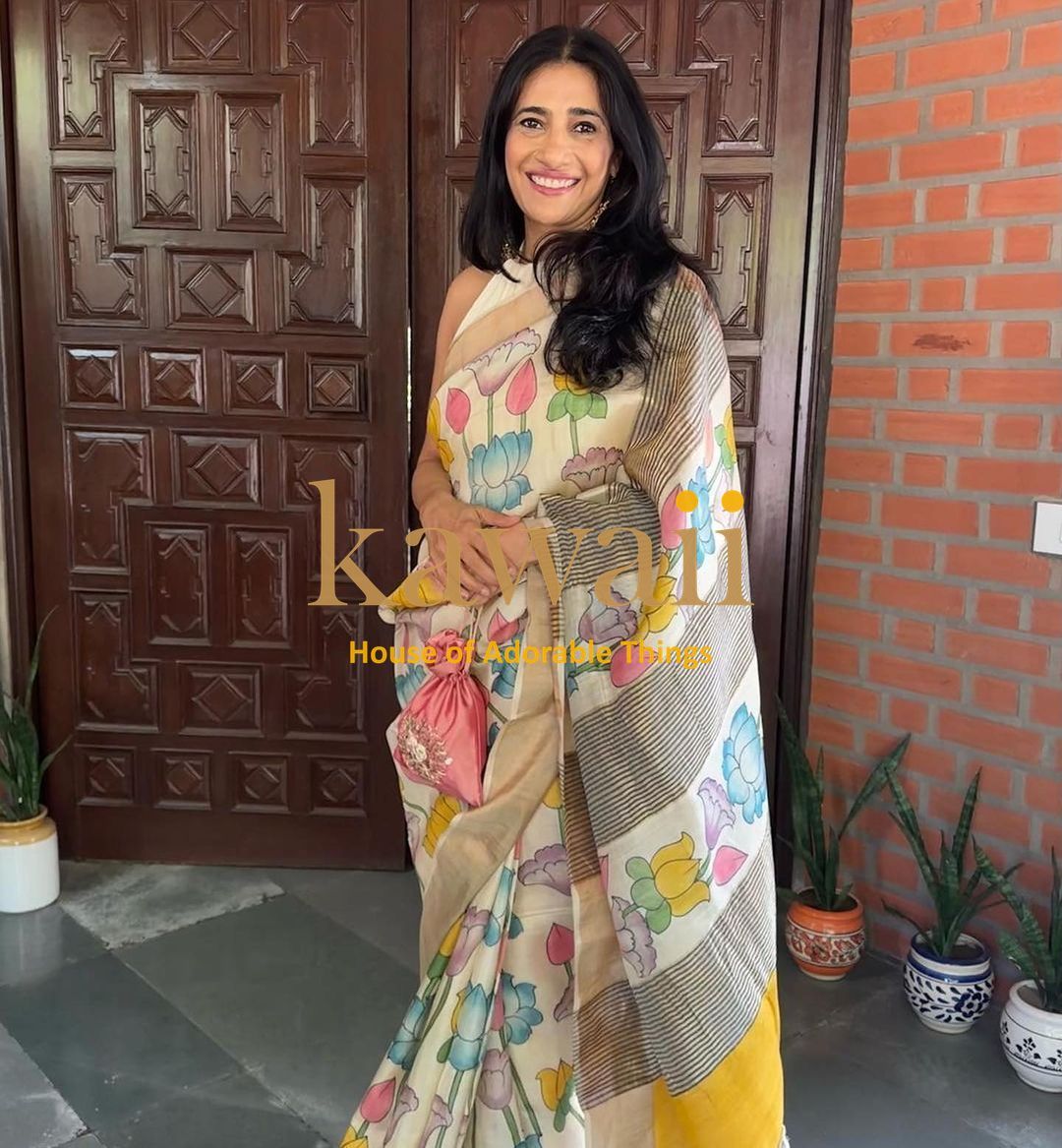 Kalamkari saree in cream with colorful floral patterns, perfect for festive occasions and traditional wear