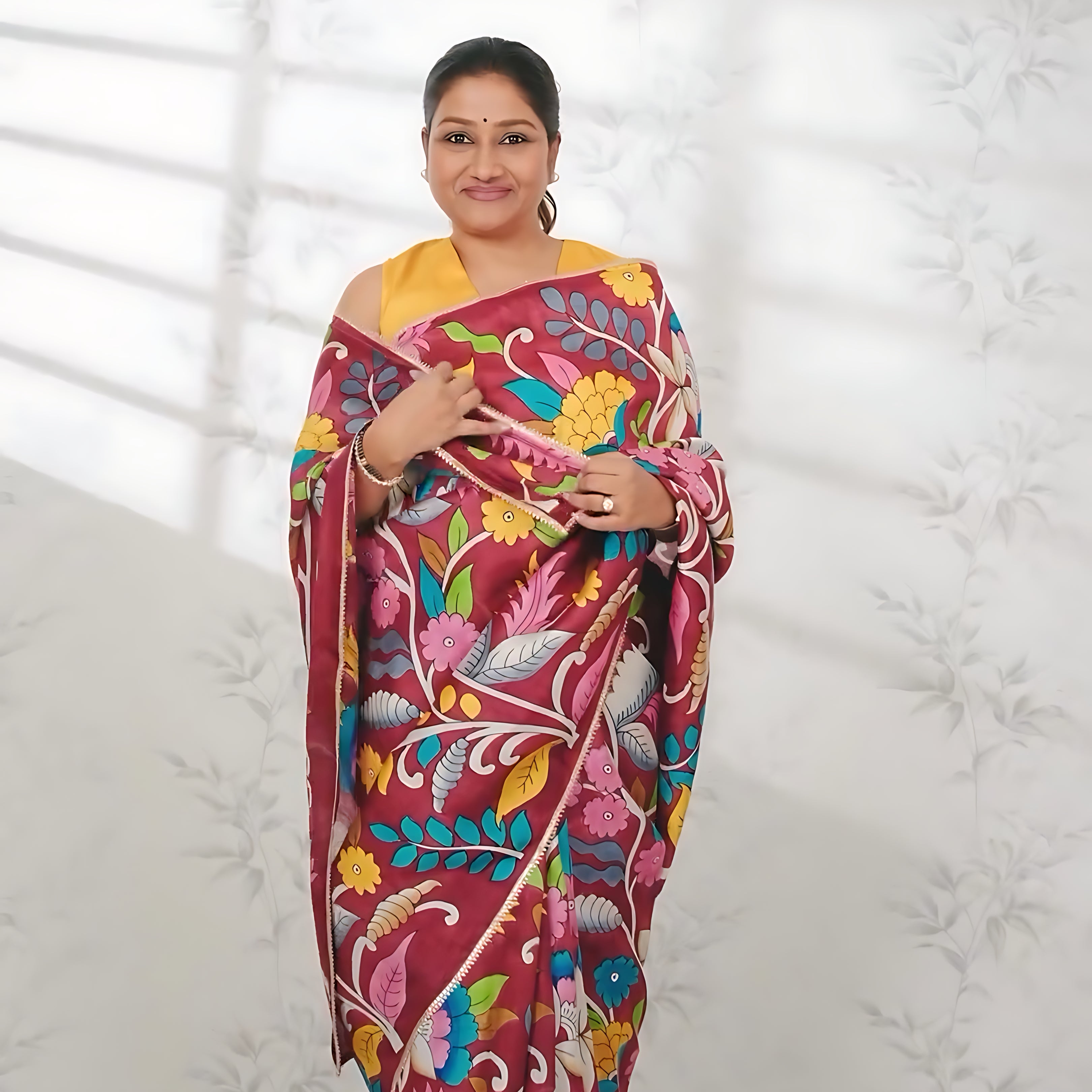 Woman wearing a vibrant floral printed kalamkari saree by Kawaii with pink and yellow colors