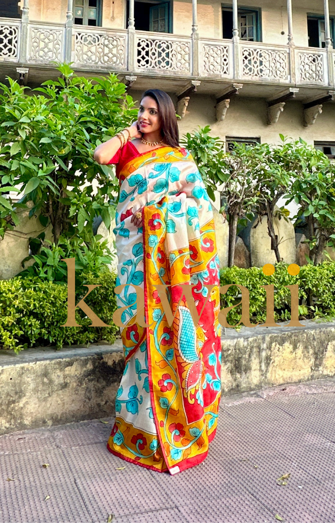 Colorful kalamkari saree in white with vibrant floral patterns and intricate designs, ideal for festive occasions
