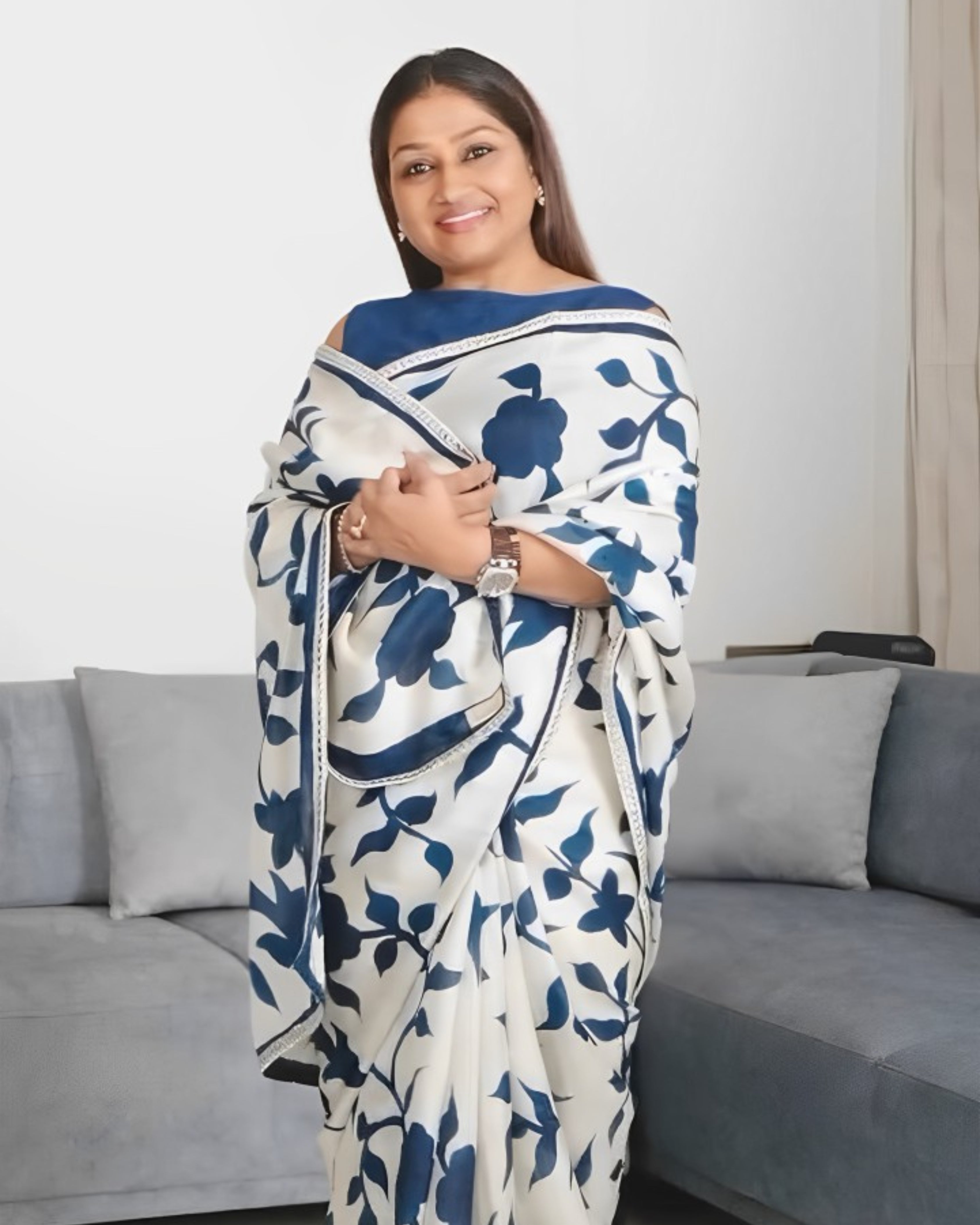 Kawaii cotton kalamkari saree in white with blue floral patterns worn by smiling woman
