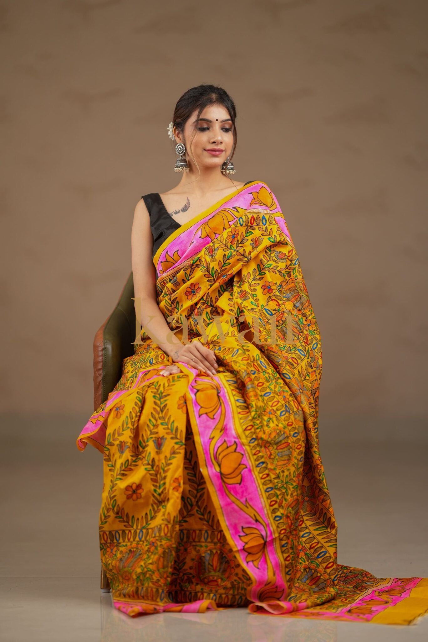 Kalamkari saree in vibrant yellow with intricate floral patterns and a pink border, crafted from soft fabric