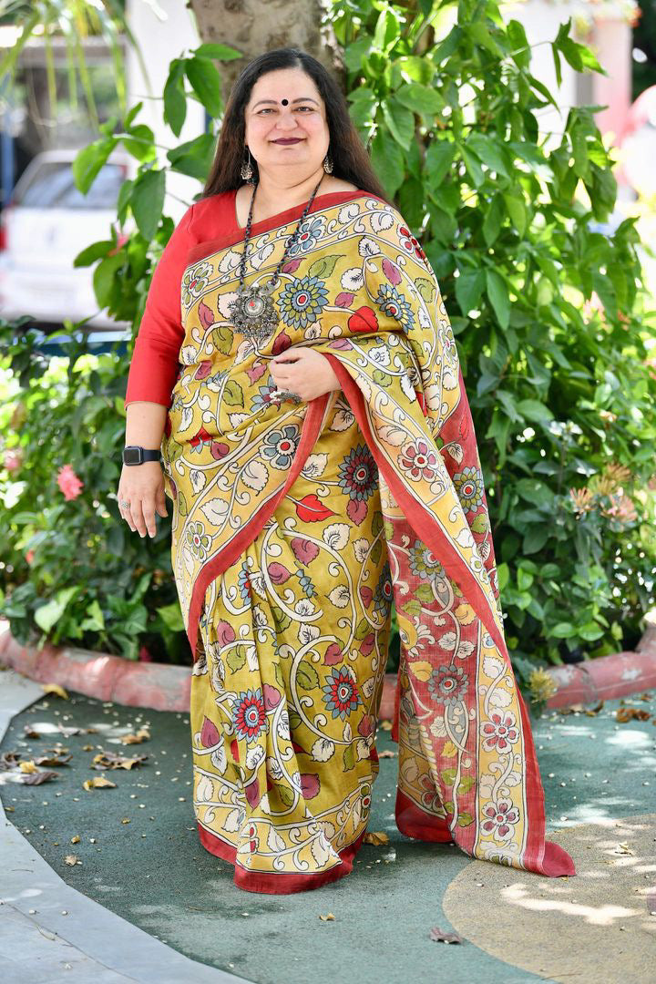 Kawaii kalamkari saree with intricate floral patterns worn by woman with red blouse outdoors