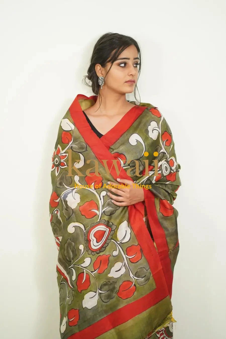 Kawaii kalamkari saree in olive green with red and white floral patterns worn by woman