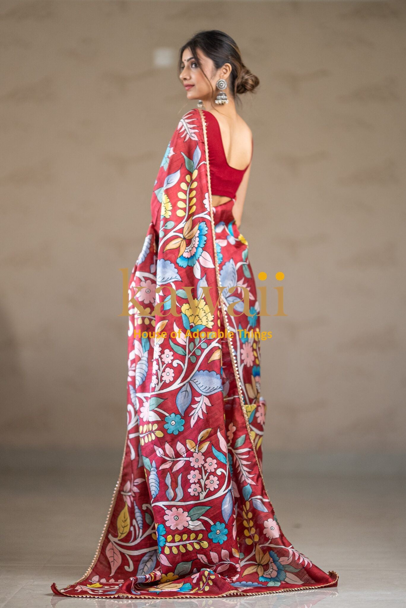 Kawaii brand kalamkari saree with vibrant floral designs worn by model with red blouse