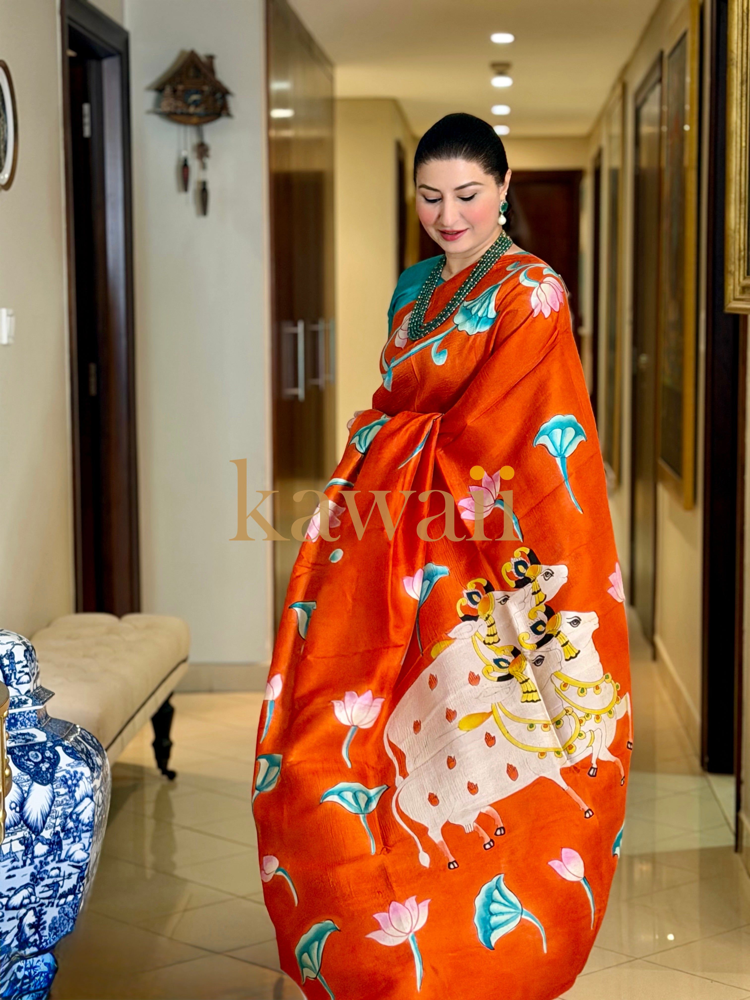 Elegant Kawaii pichwai saree in vibrant orange featuring traditional motifs and intricate designs