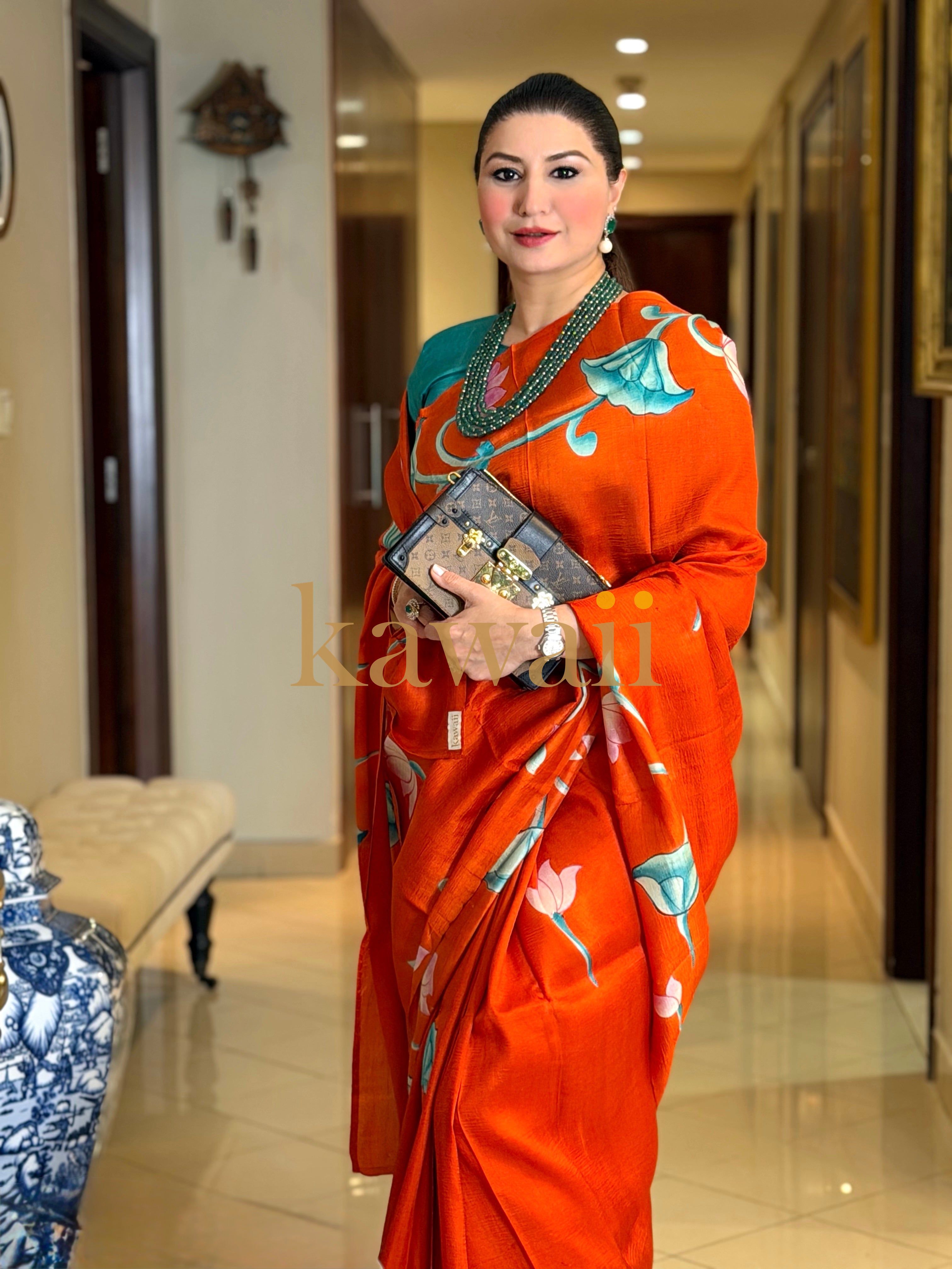 Stunning pichwai saree in orange with floral patterns, perfect for festive occasions