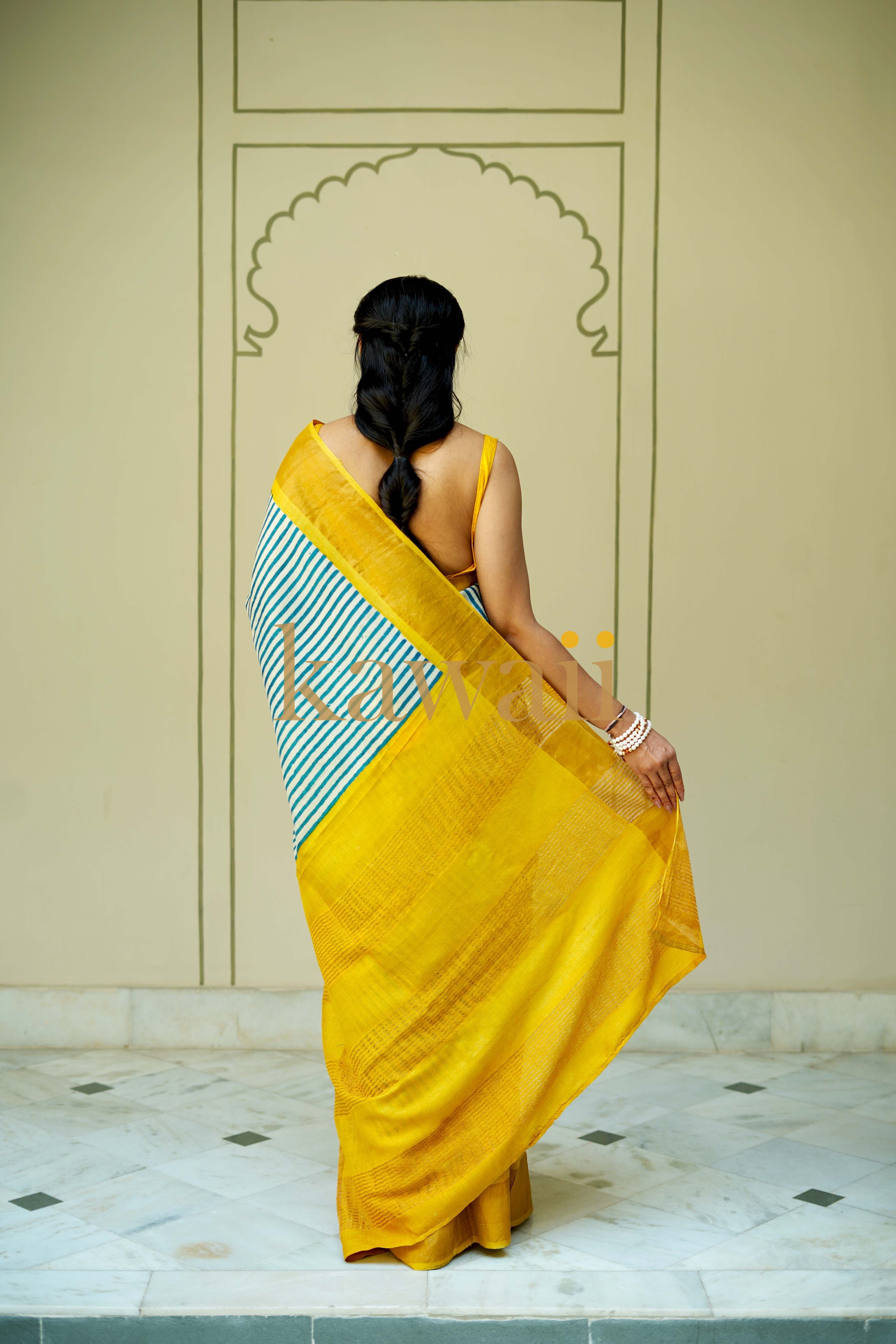Beautiful block print tussar silk saree in yellow with green striped border, perfect for festive occasions