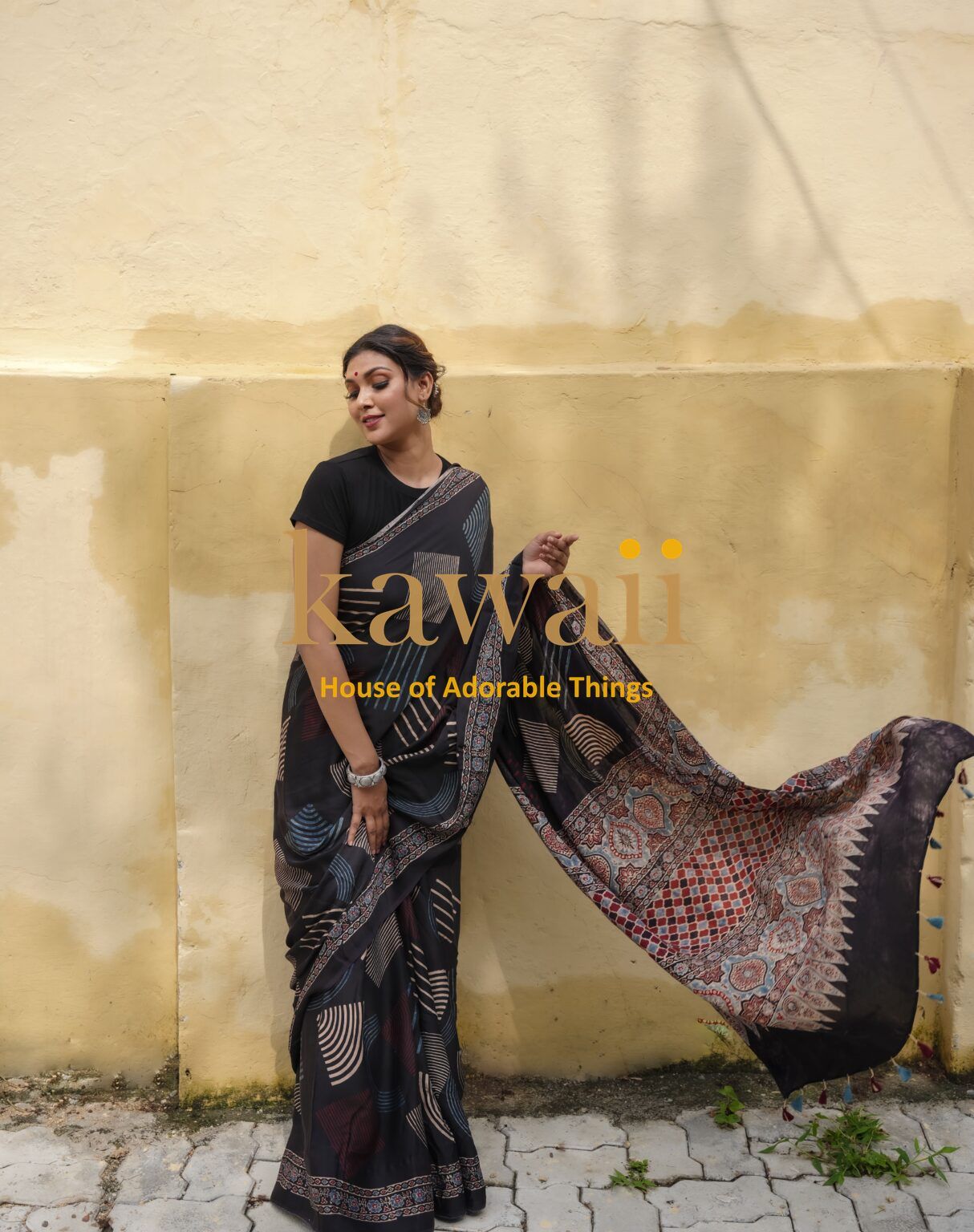 Woman wearing black and multicolor ajrakh saree with traditional patterns from Kawaii
