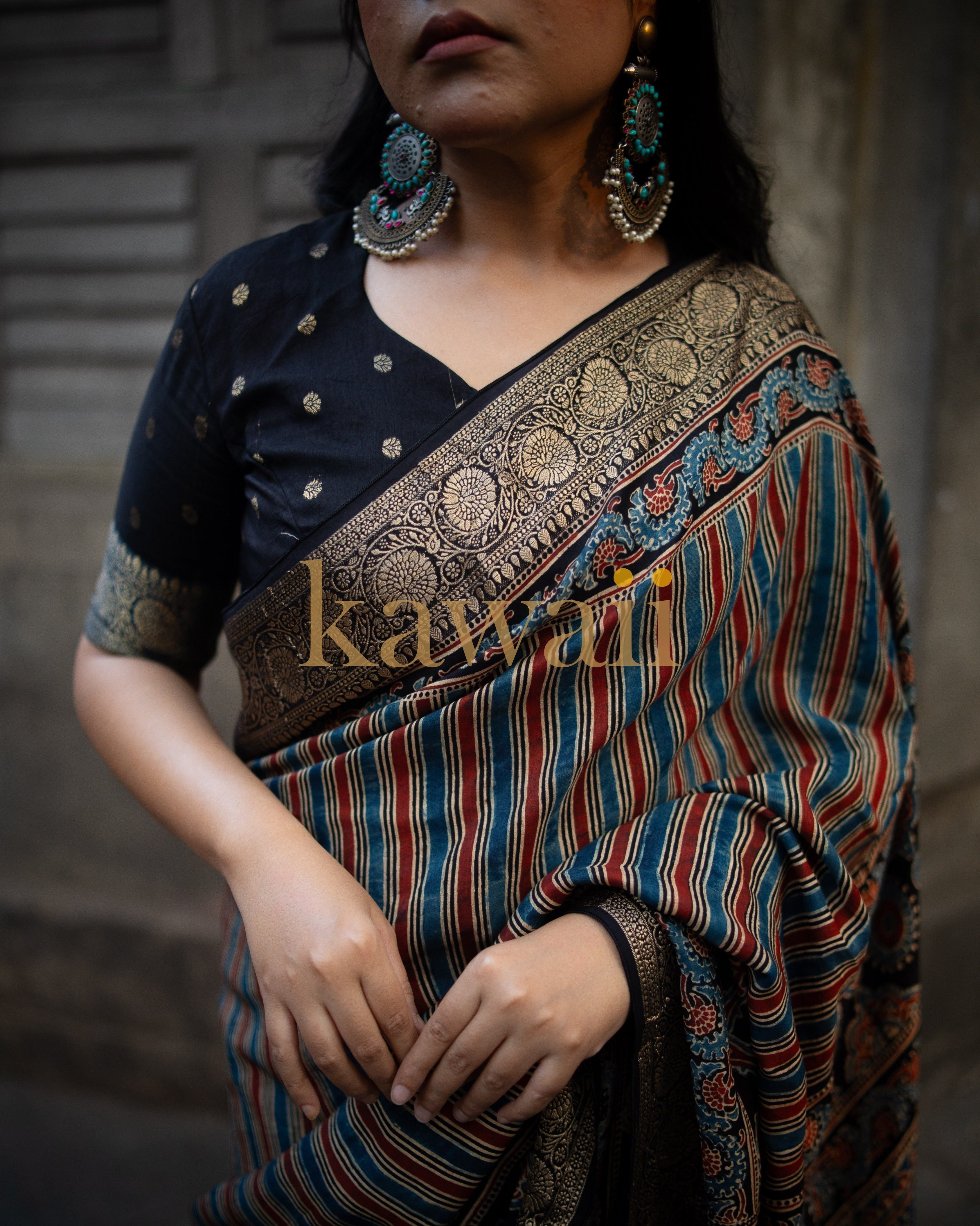 Kawaii ajrakh saree with intricate gold border and multicolor striped pattern worn with black blouse