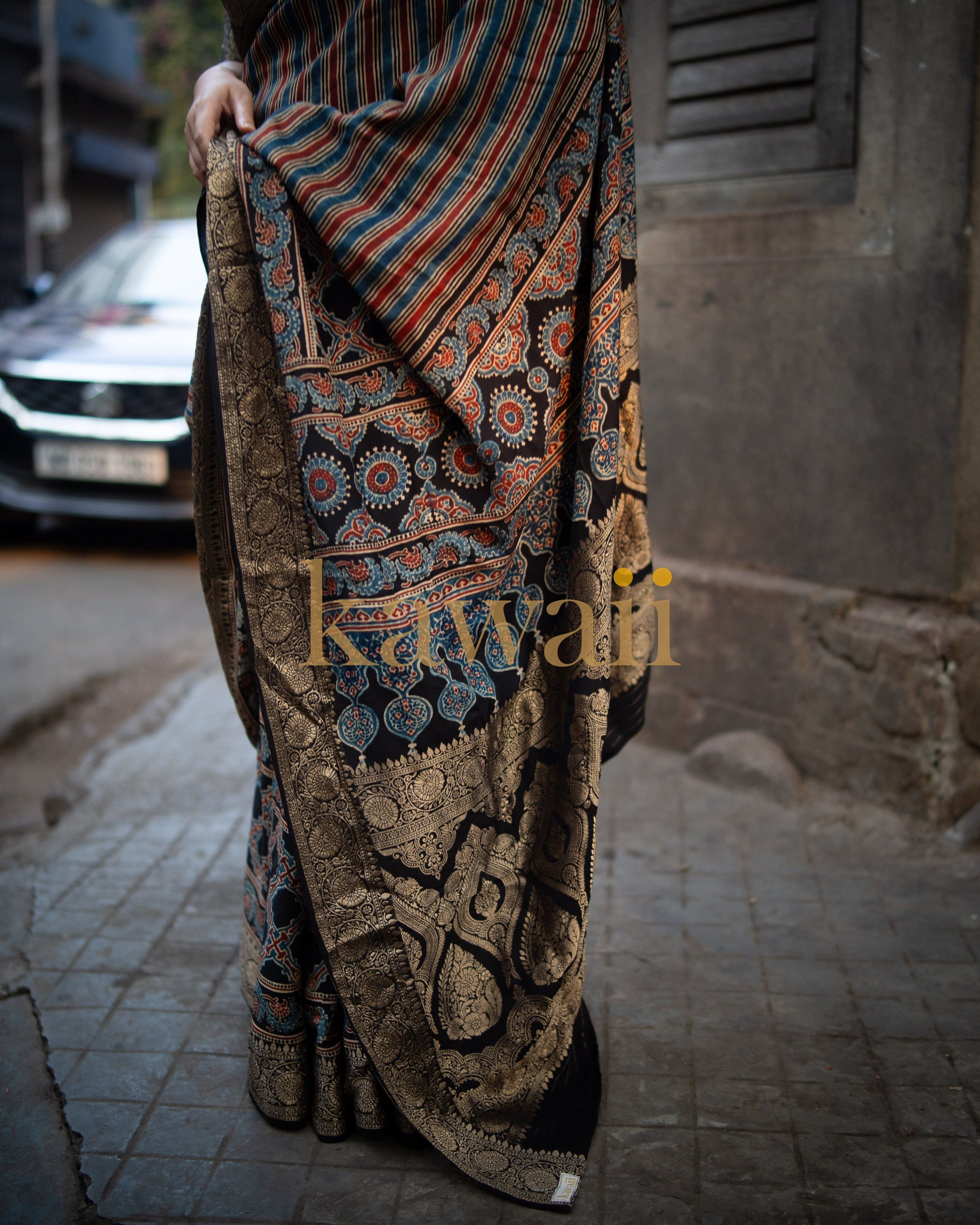 Kawaii ajrakh saree featuring intricate traditional patterns in earthy tones worn by a person outdoors