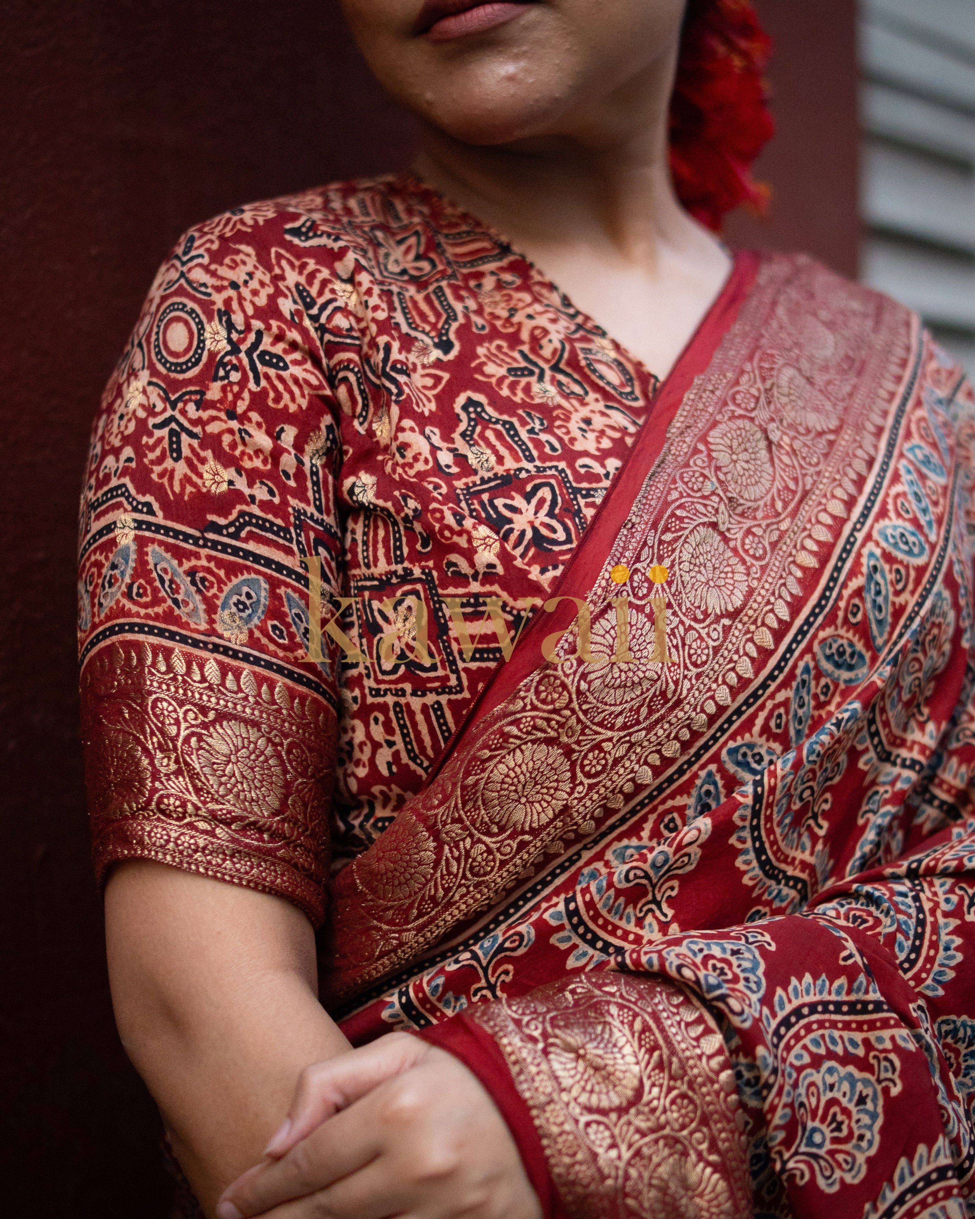 Close-up of Kawaii ajrakh saree in red with intricate gold and black traditional patterns