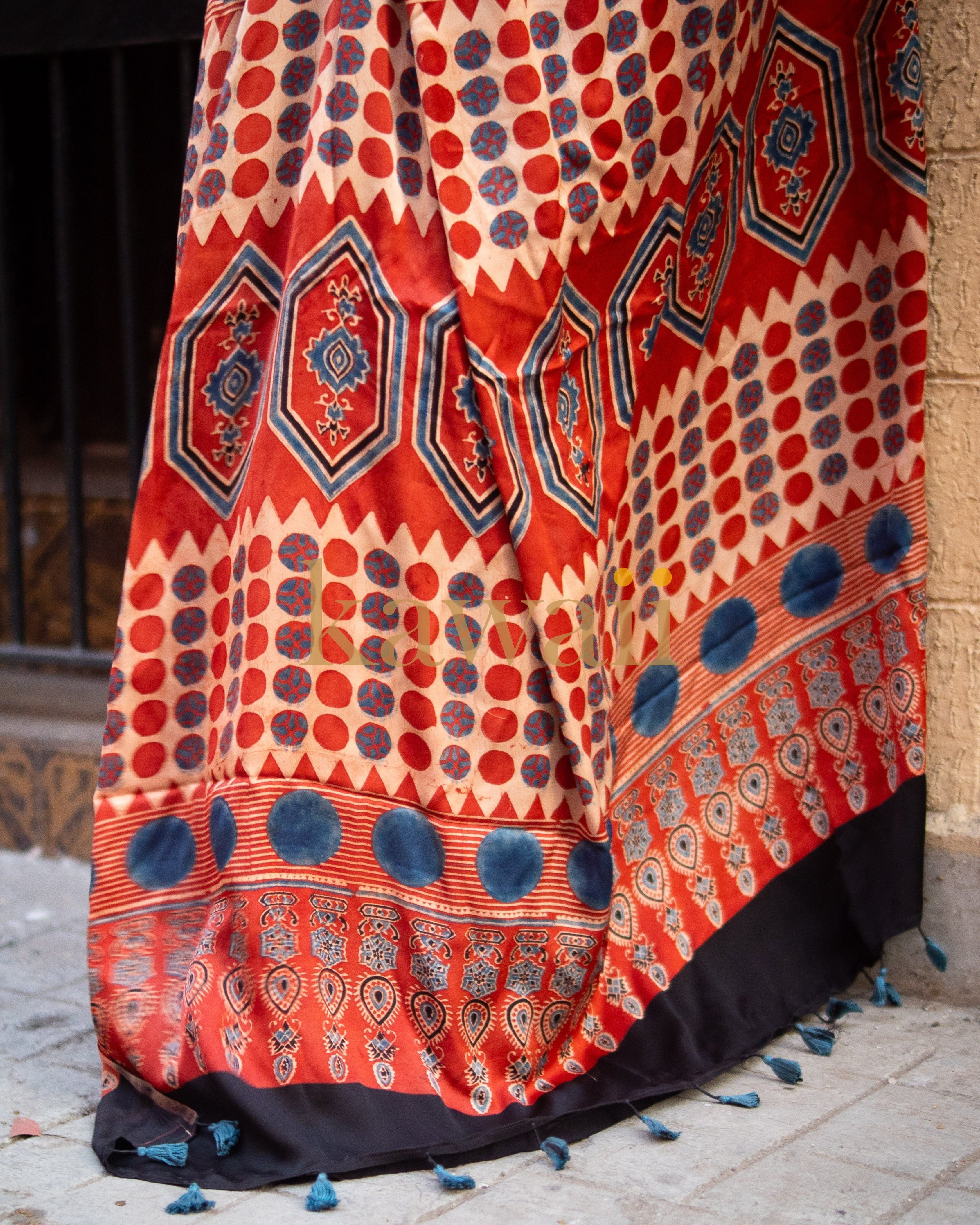 Kawaii ajrakh saree with traditional red, blue, and beige geometric patterns and black tassel border