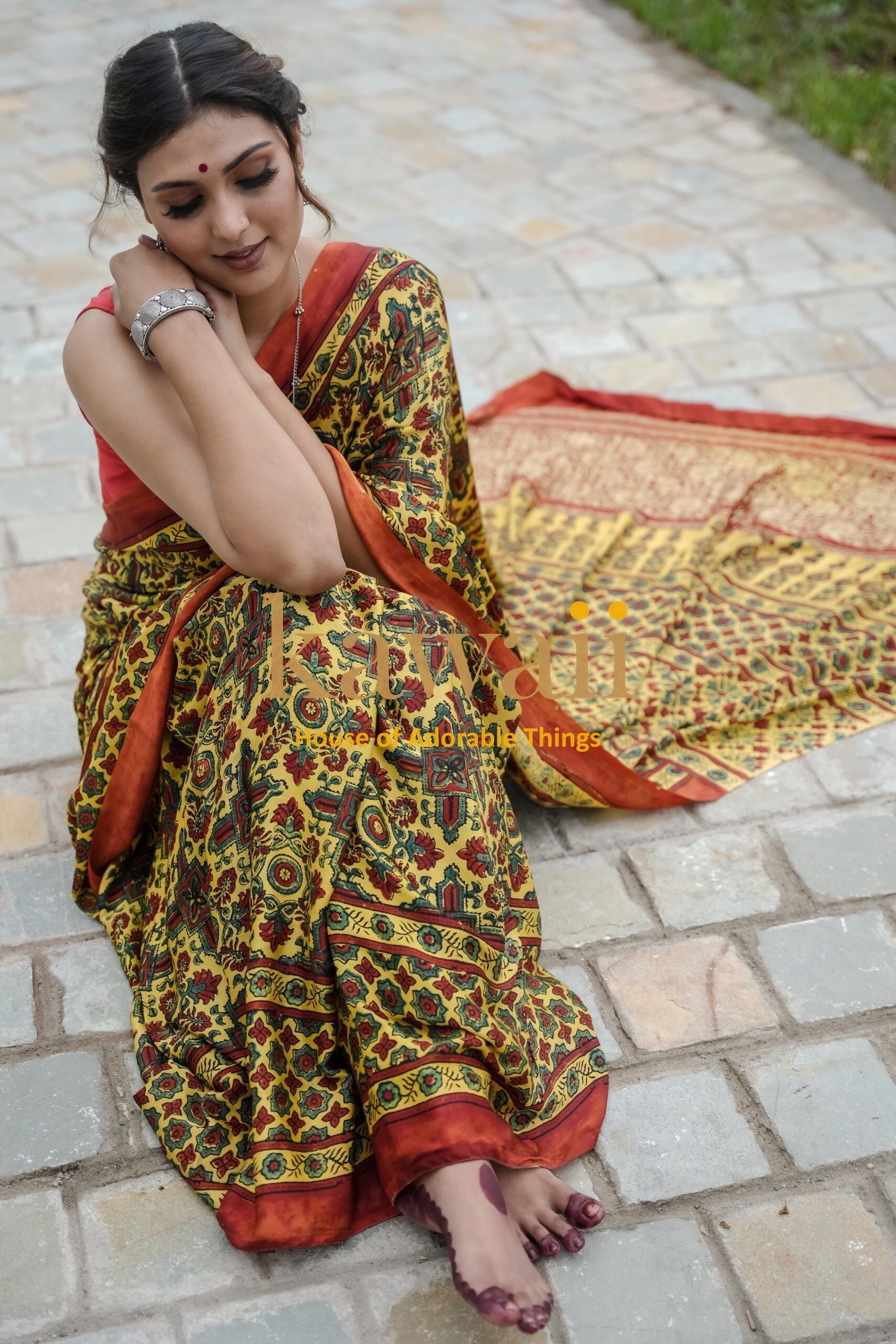 Woman wearing traditional ajrakh saree from Kawaii with intricate patterns and earthy tones