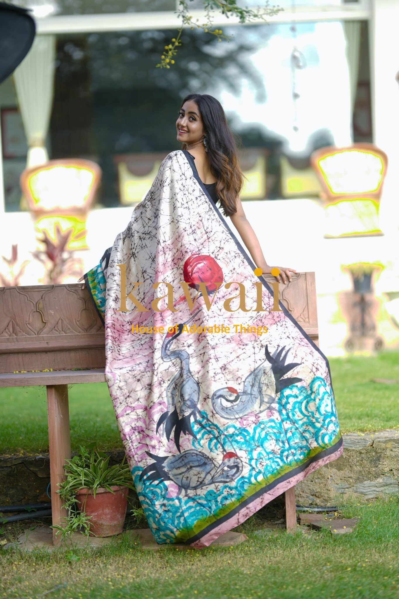 Woman wearing a colorful Kawaii batik saree with intricate bird and wave patterns outdoors