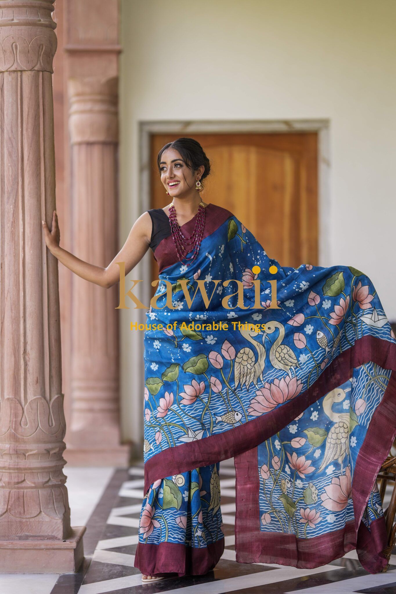 Kawaii Kalamkari saree in blue with floral and bird motifs, showcasing traditional batik saree design