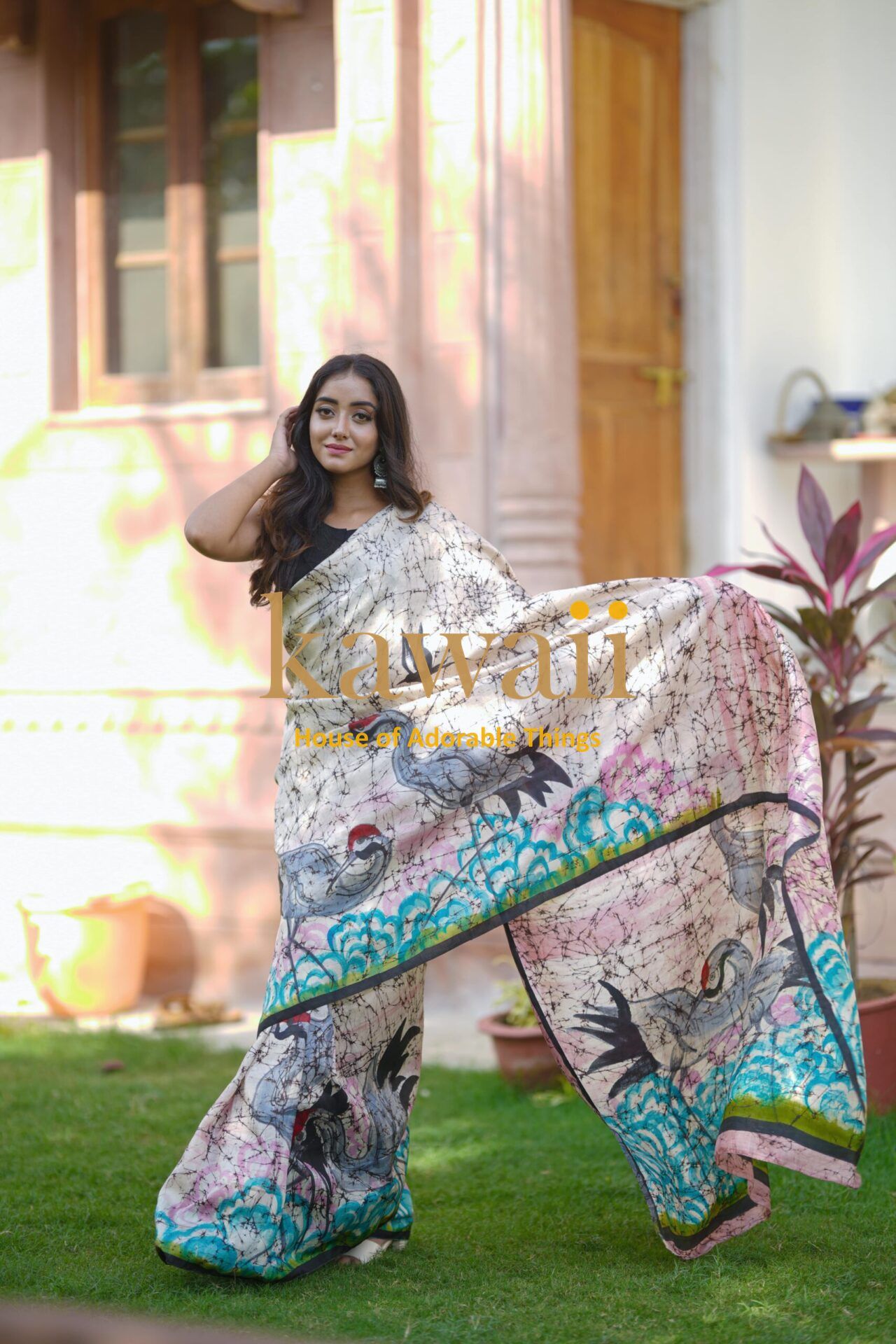Kawaii batik saree with intricate bird and floral patterns worn by woman outdoors