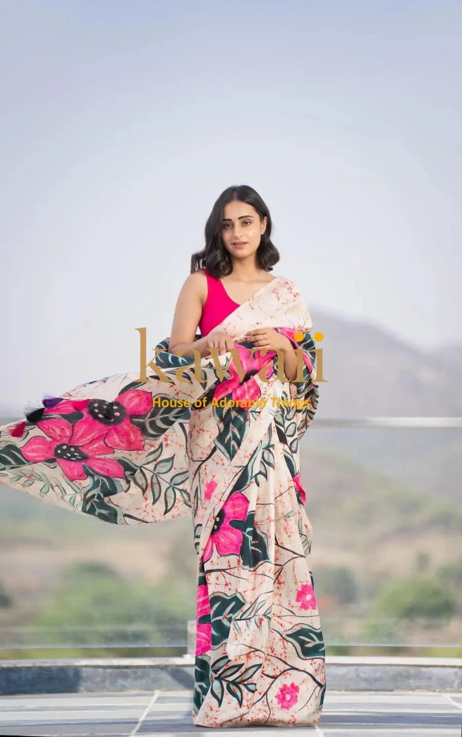 Kawaii batik saree with vibrant pink floral and green leaf patterns worn by woman outdoors