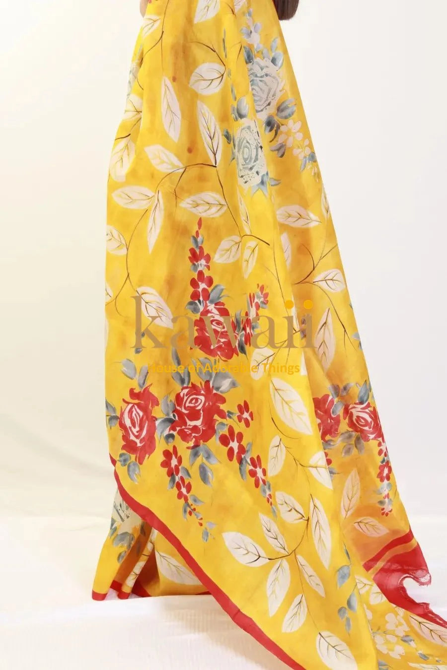 Kawaii yellow batik saree with red and blue floral print and leaf patterns draped gracefully