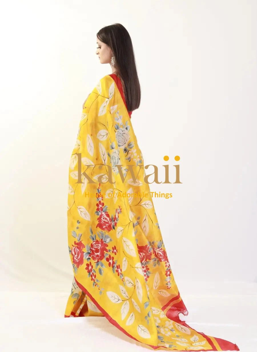 Kawaii yellow batik saree with floral patterns and red border worn by model