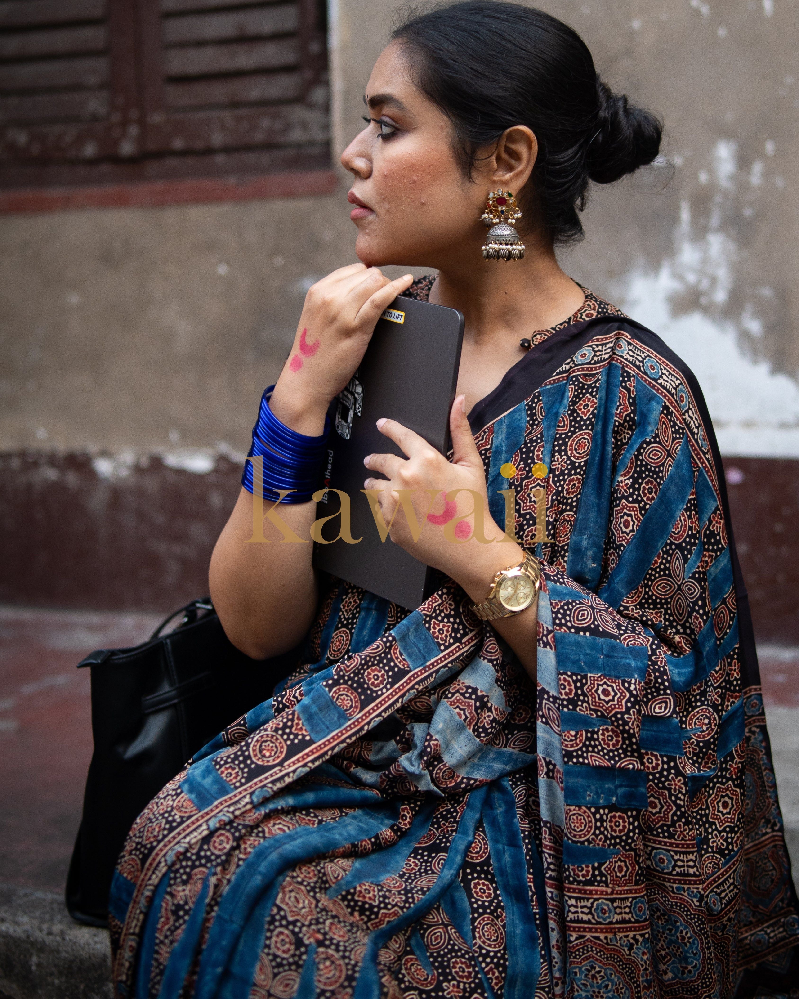 Woman wearing best ajrakh saree by Kawaii with traditional geometric and floral patterns in blue and brown