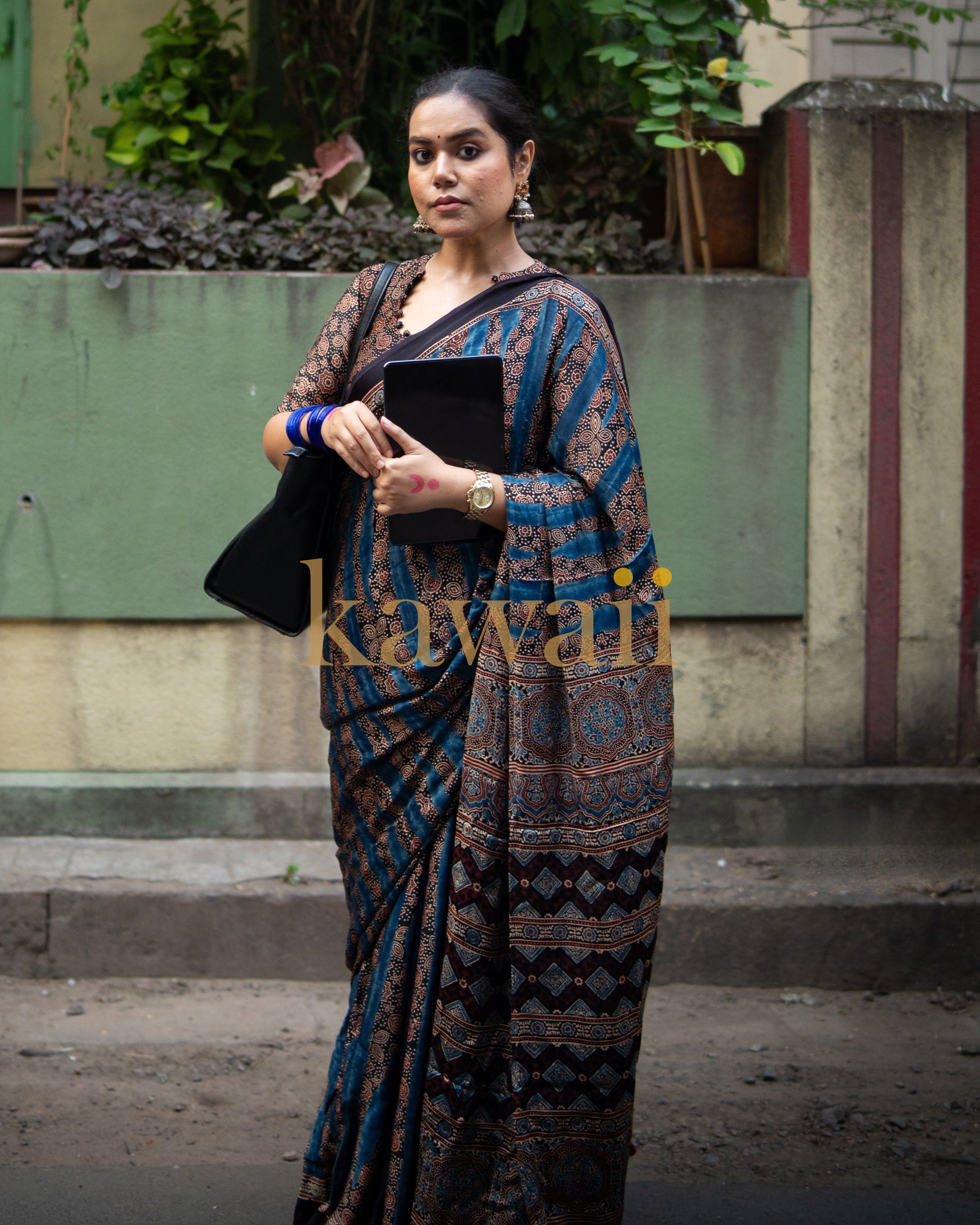 Woman wearing the best ajrakh saree by Kawaii with intricate blue and brown traditional patterns