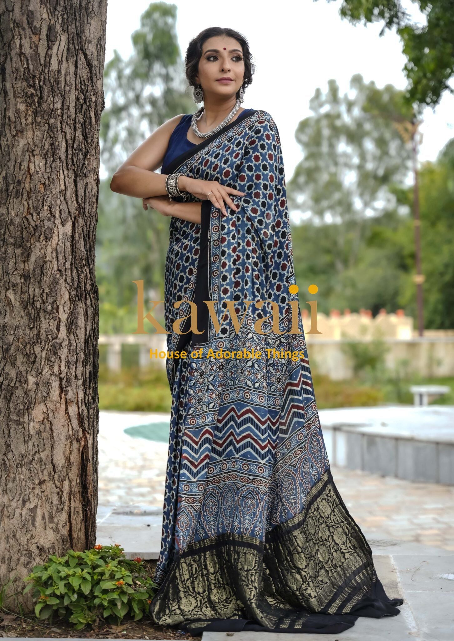 Woman wearing the best authentic handcrafted ajrakh saree online with intricate traditional patterns from Kawaii