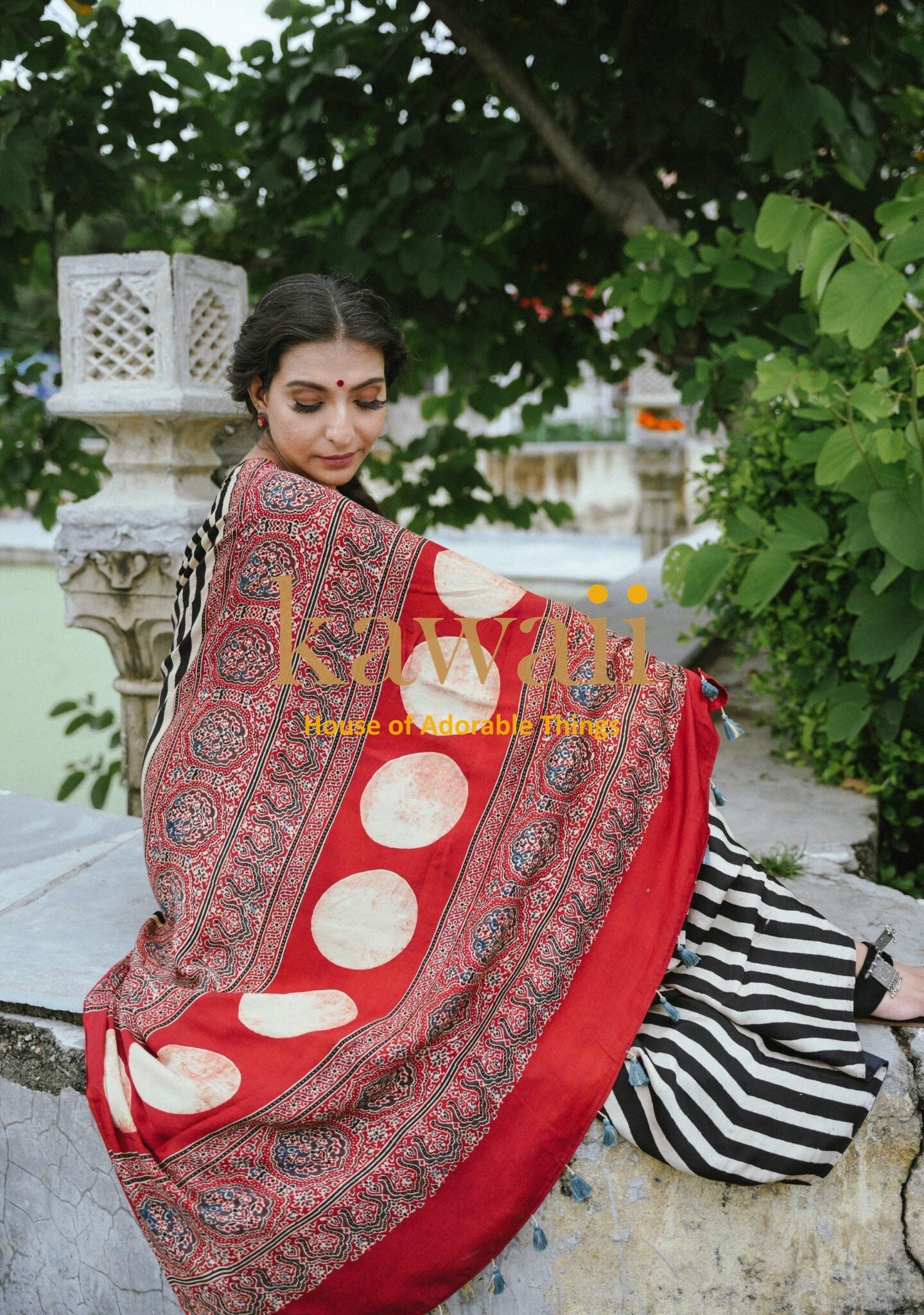 Woman wearing the Best Handcrafted Authentic Ajrakh Saree Online in red and black patterned traditional design