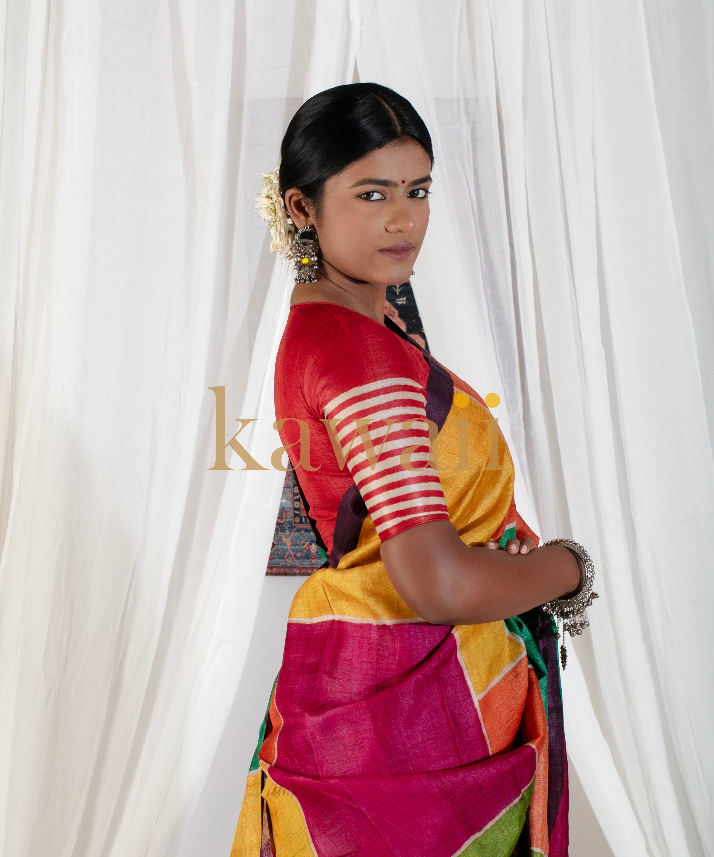 Kawaii block print saree in vibrant multicolor worn by woman with traditional jewelry and gajra in hair
