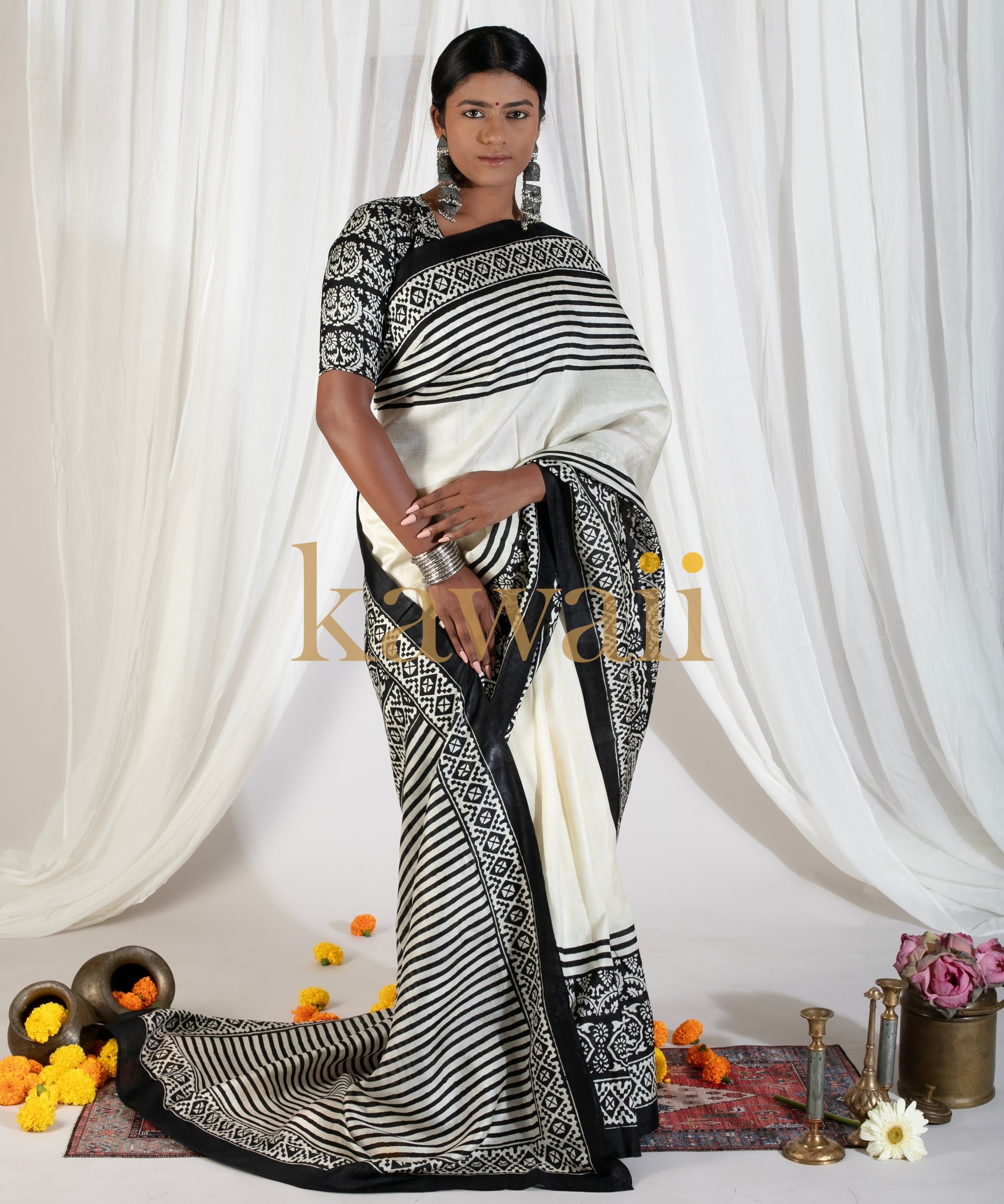Kawaii black and white block print saree with intricate patterns worn by model against white draped background