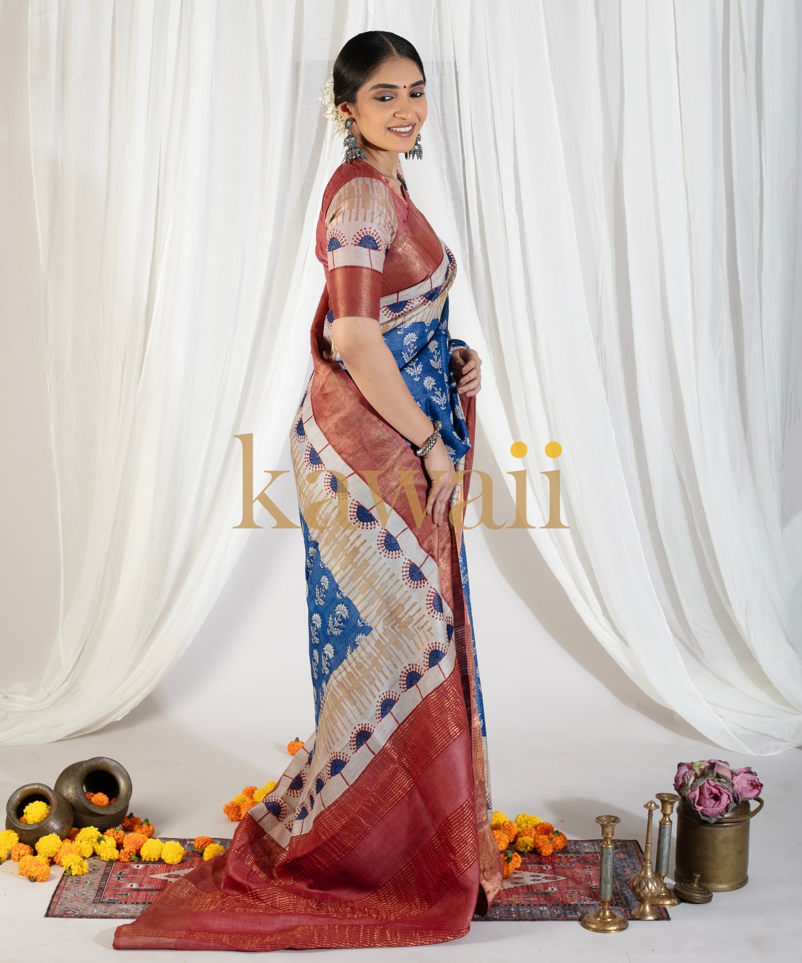 Woman wearing a traditional Kawaii block print saree in blue and maroon with intricate patterns