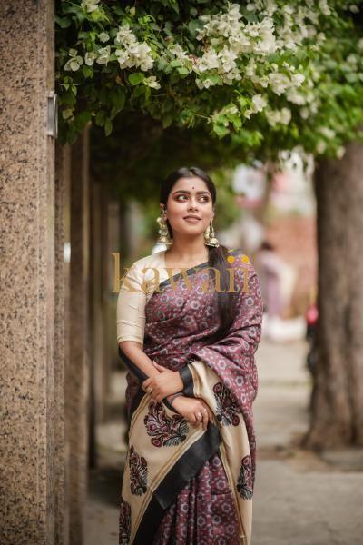 Elegant block print saree in earthy tones, featuring intricate floral designs, perfect for festive occasions.