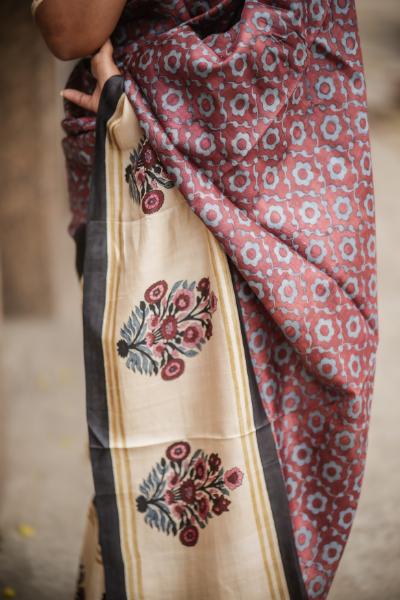 Elegant Kawaii block print saree featuring floral designs in vibrant colors and a contrasting border