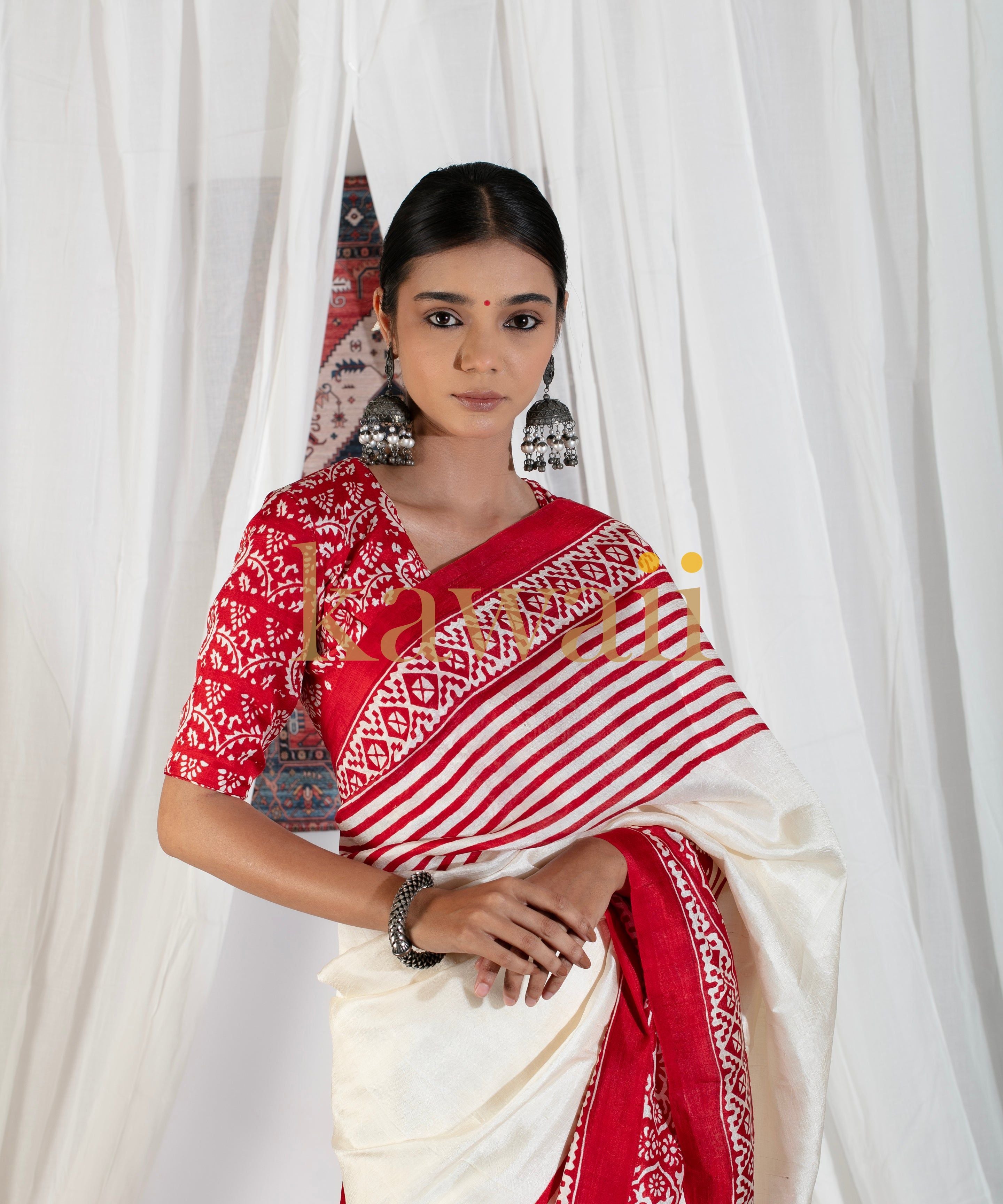 Woman wearing traditional red and white block print saree by Kawaii with intricate patterns and matching blouse