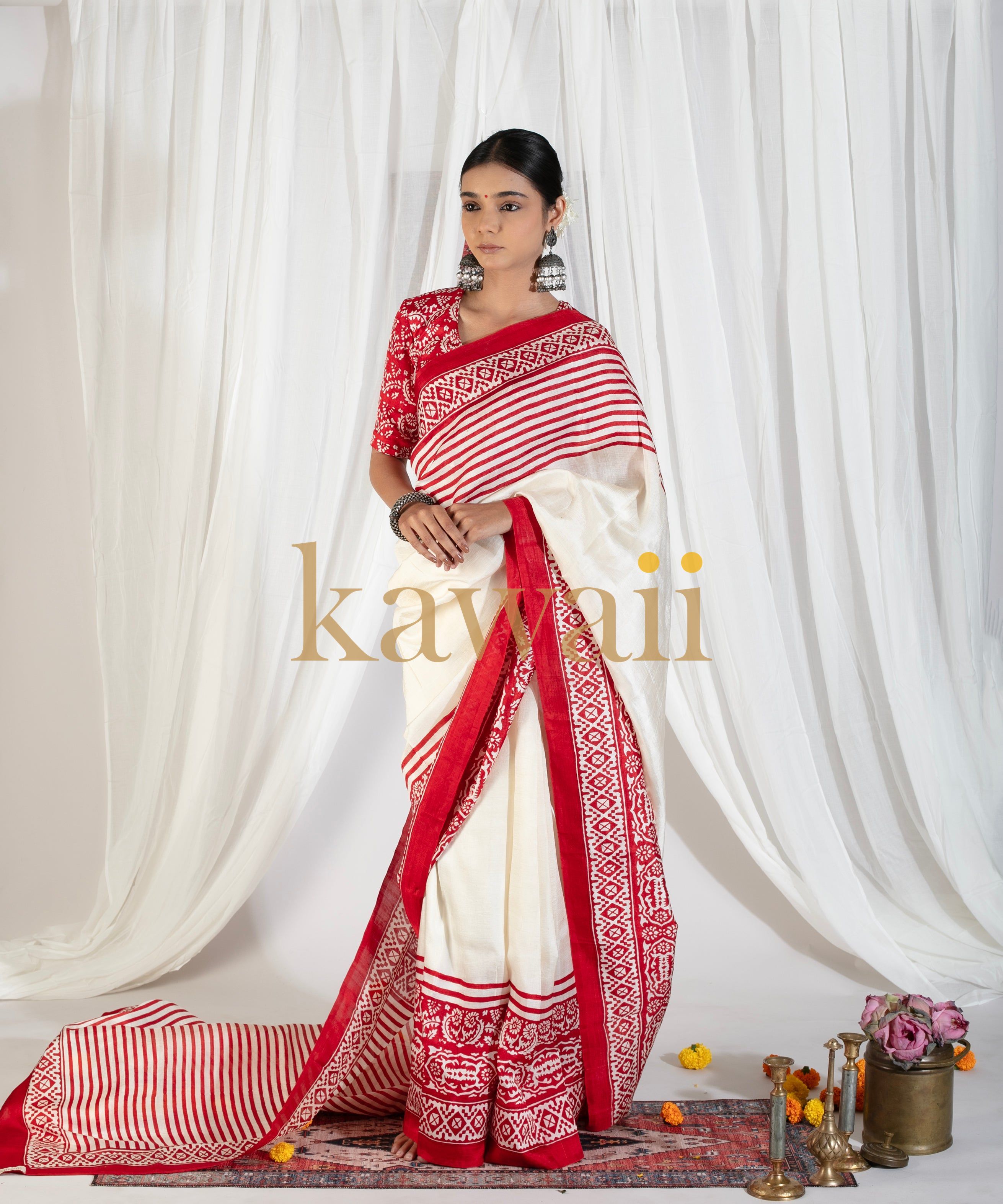 Kawaii block print saree in white and red with intricate geometric patterns worn by a woman