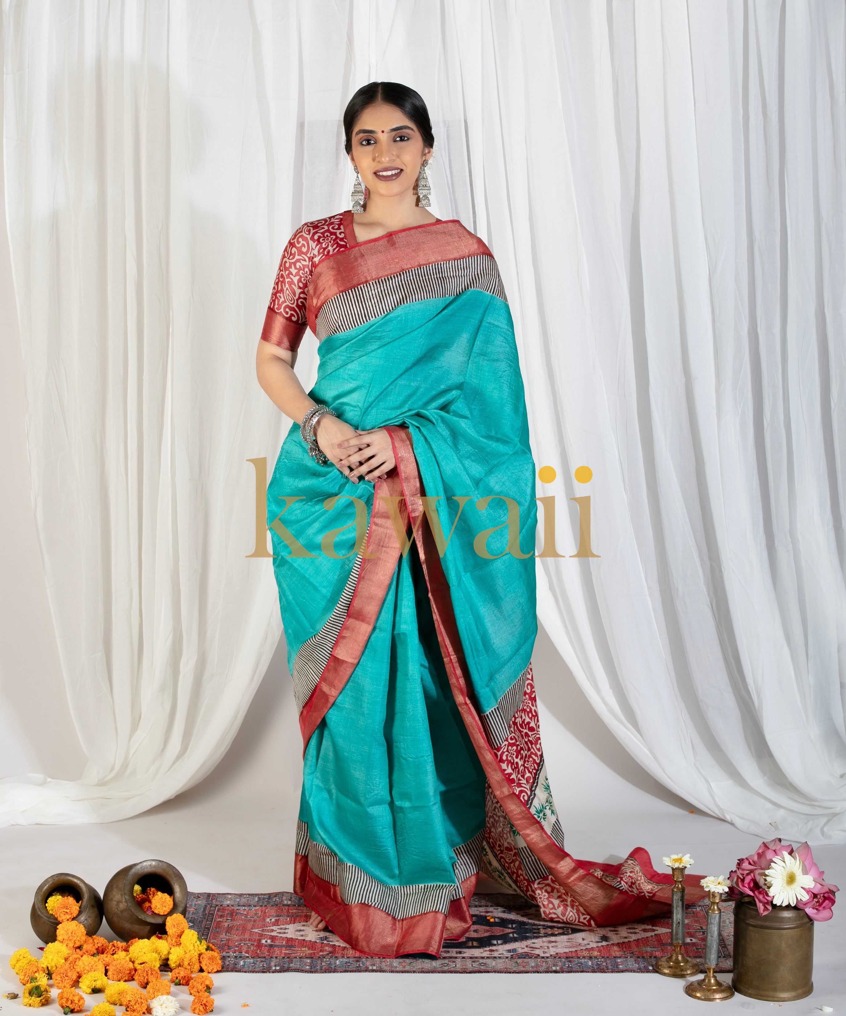Kawaii turquoise and red block print saree worn by a woman with floral decor