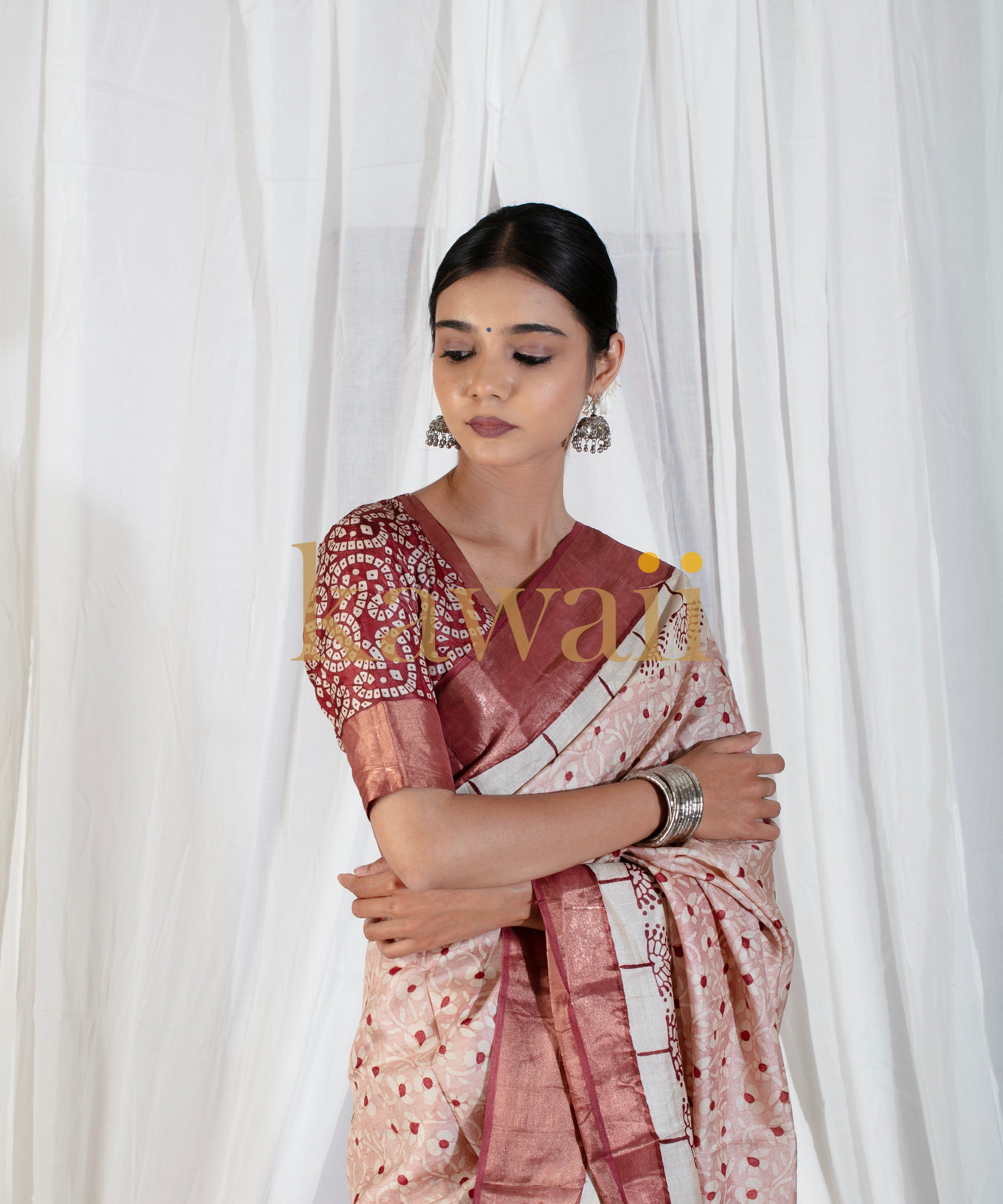 Woman wearing Kawaii elegant maroon and cream block print saree with traditional jewelry