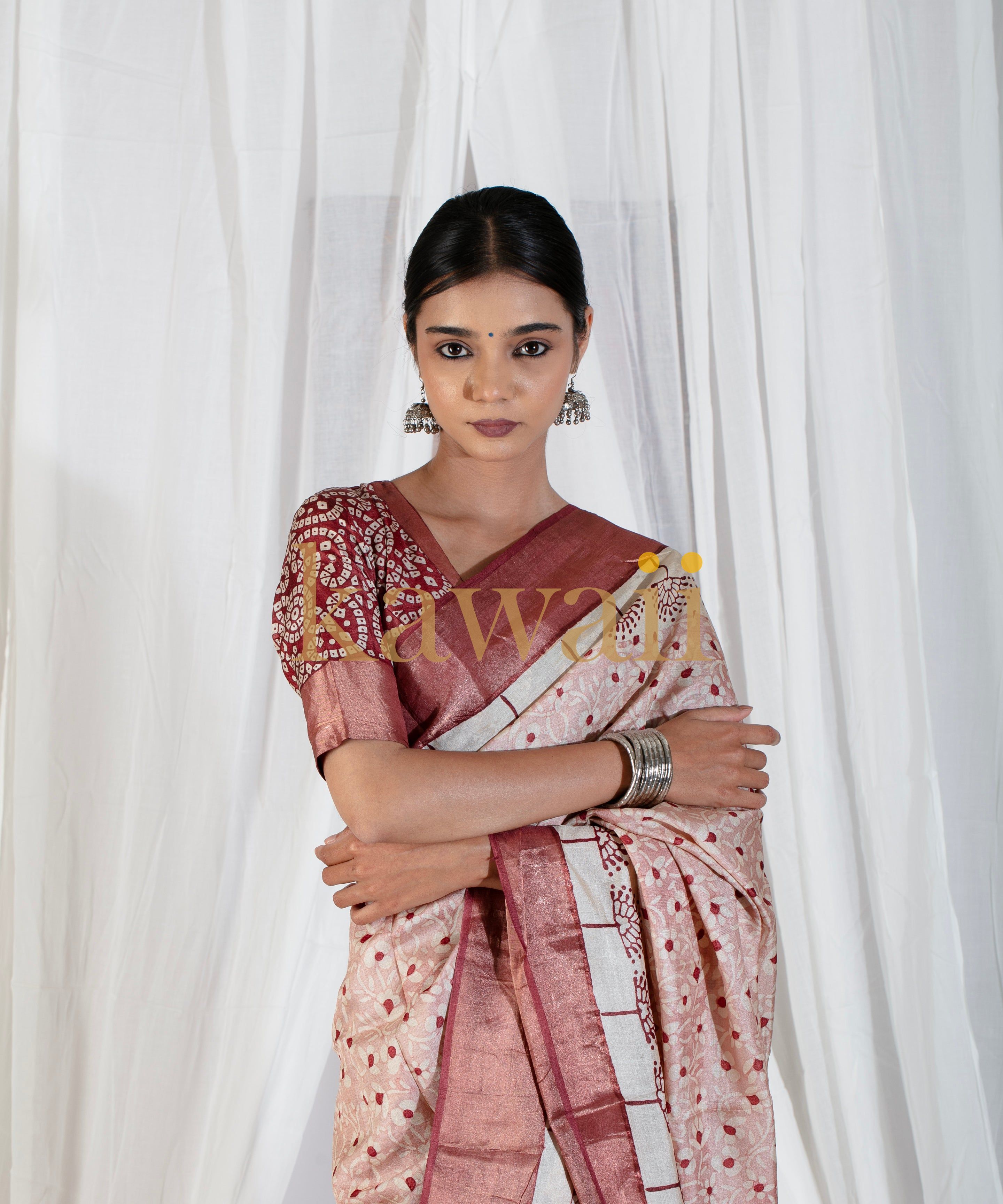 Woman wearing a Kawaii block print saree in maroon and cream with traditional jewelry