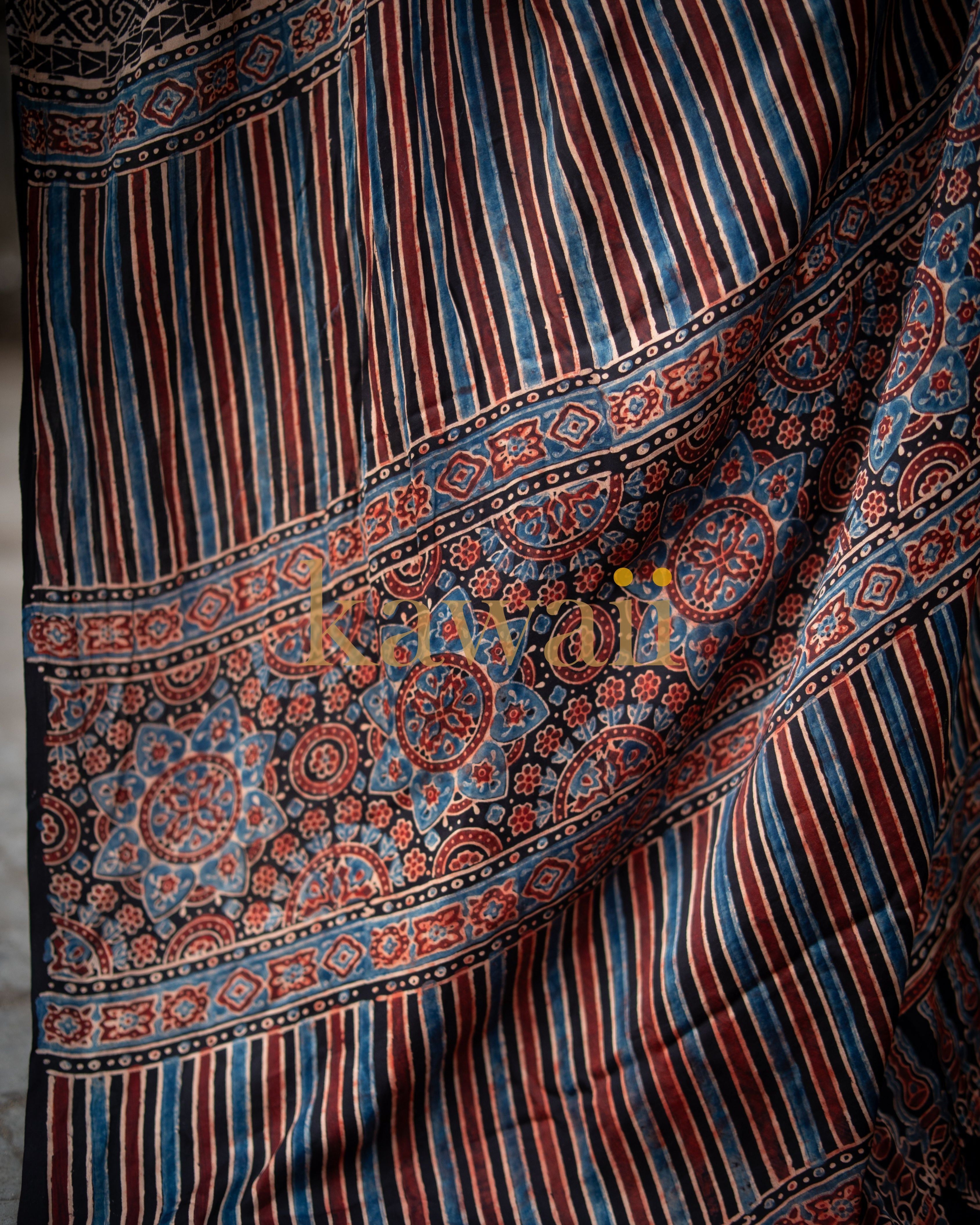 Handcrafted Ajrakh saree with intricate floral and striped patterns in blue and red tones