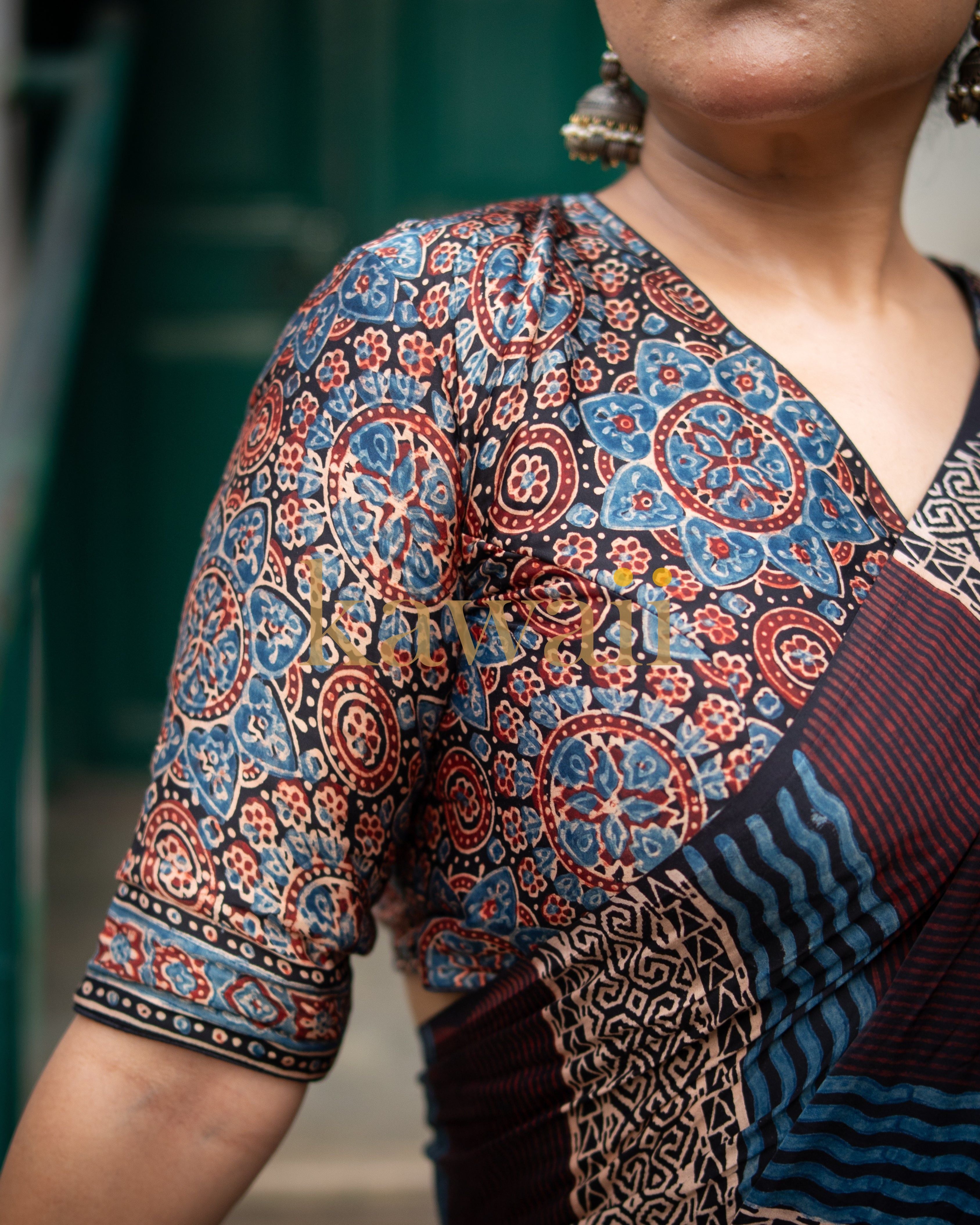 Close-up of Kawaii handcrafted ajrakh saree blouse with intricate blue and red floral patterns