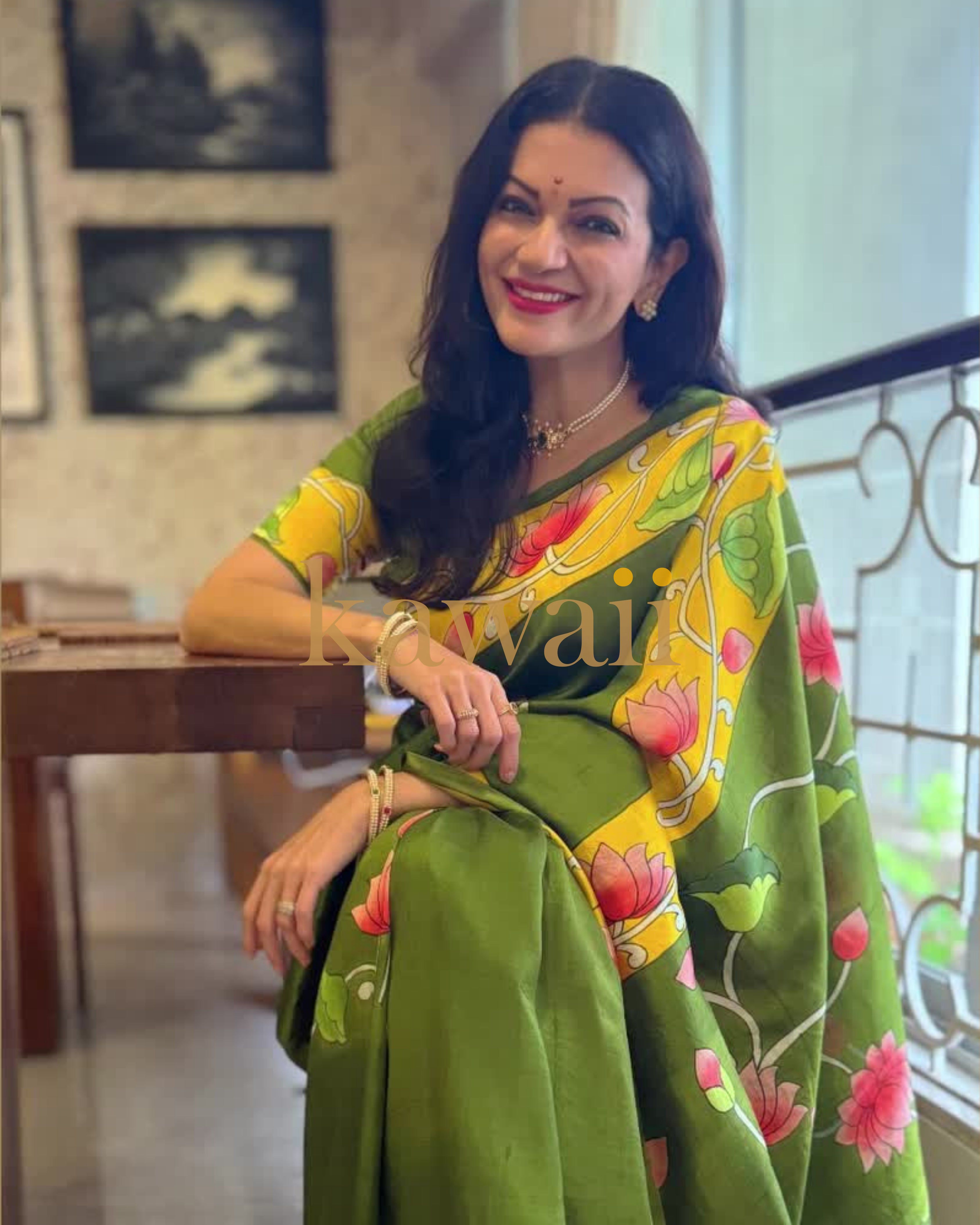 Vibrant green pichwai saree with floral motifs, crafted in lightweight fabric by Kawaii for elegant occasions