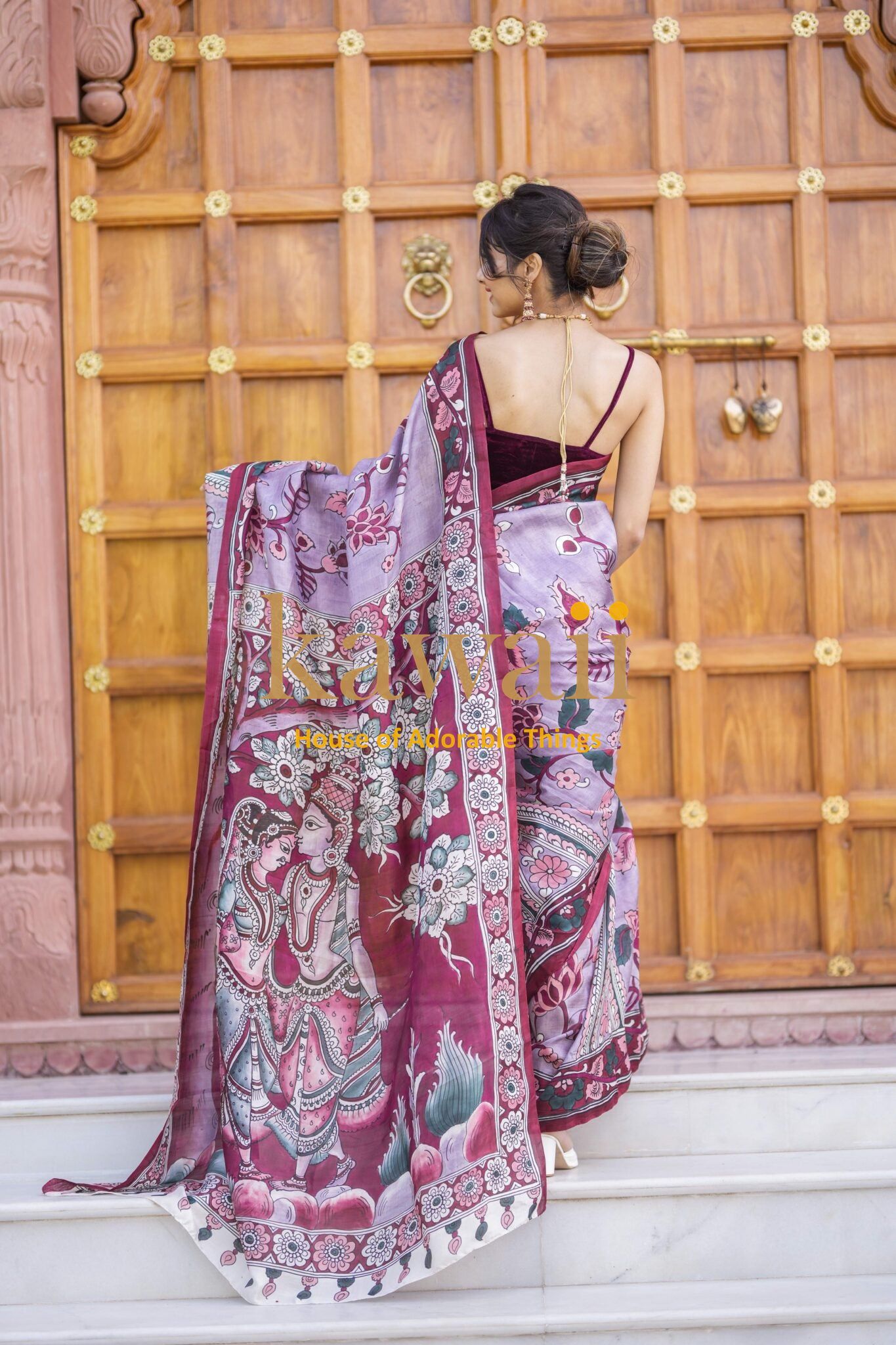 Kawaii kalamkari saree in maroon and lavender with intricate traditional designs worn by a woman