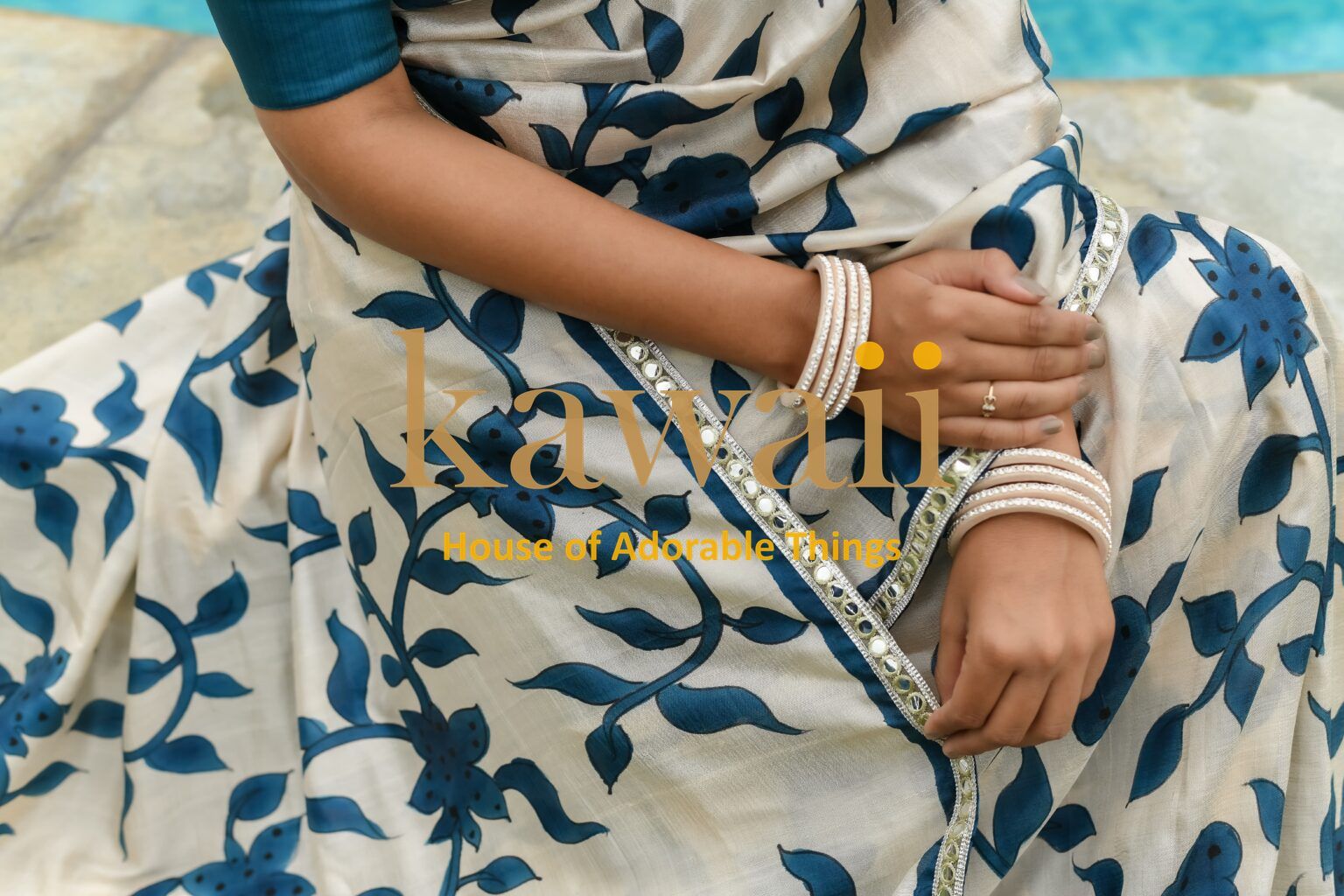 Kawaii kalamkari saree in cream with blue floral print worn with bangles